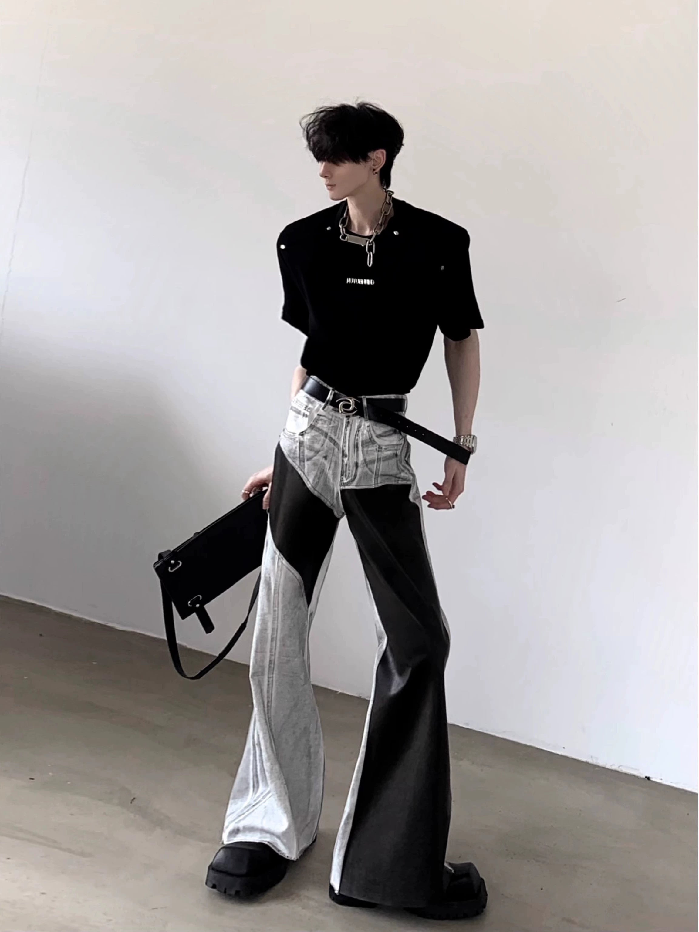 The Sanhoostudio distressed off-white jeans combine premium leather patchwork with a subtle flared cut. Their faded finish adds a rugged vintage vibe, while the unique detailing enhances versatility, making them a must-have for bold, high-fashion urban wardrobes.