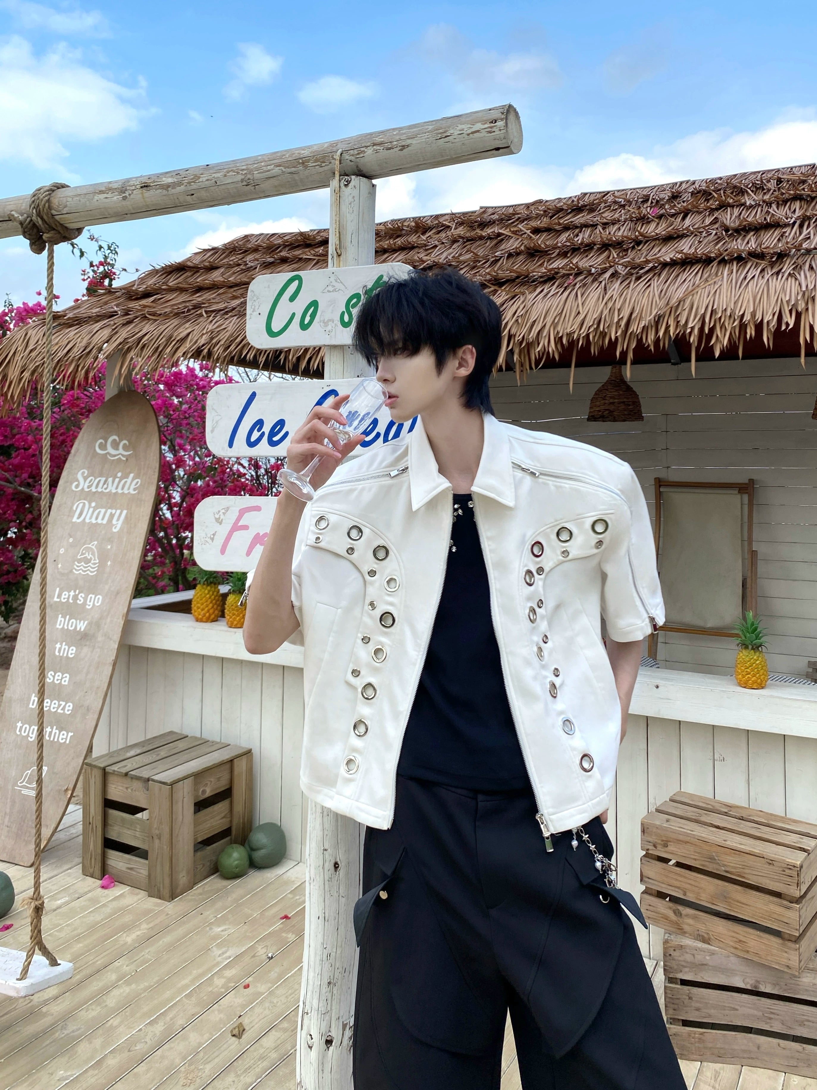 This avant-garde cropped jacket by Sanhoostudio showcases futuristic hollow-metal inspired cutouts with bold shoulder pads. Its oversized silhouette, lightweight material, and modern edge make it a standout layering piece for streetwear fans who embrace unique design and cutting-edge style.