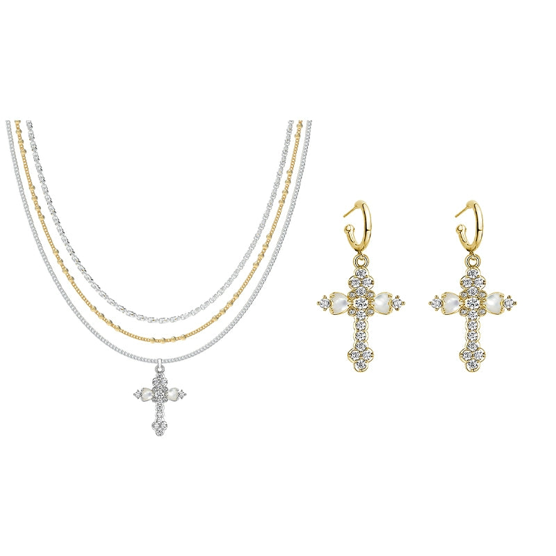 Embrace soft elegance with Sanhoostudio’s layered petal cross necklace. Adorned with mother-of-pearl accents, it brings timeless charm and modern refinement to your style.