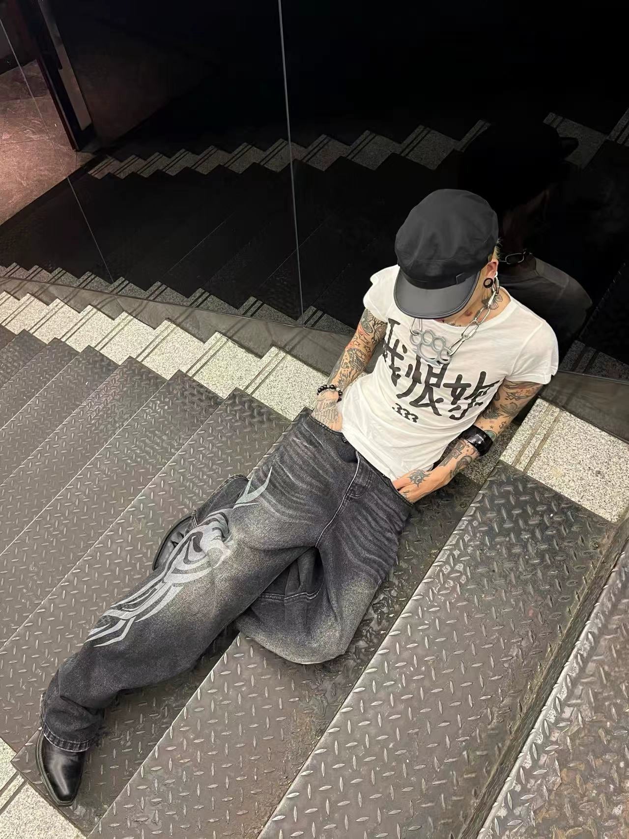 These Sanhoostudio jeans showcase bold totem rune prints across a wide-leg straight cut. The oversized fit and retro wash add cultural inspiration to streetwear, making them a unique fashion-forward piece.