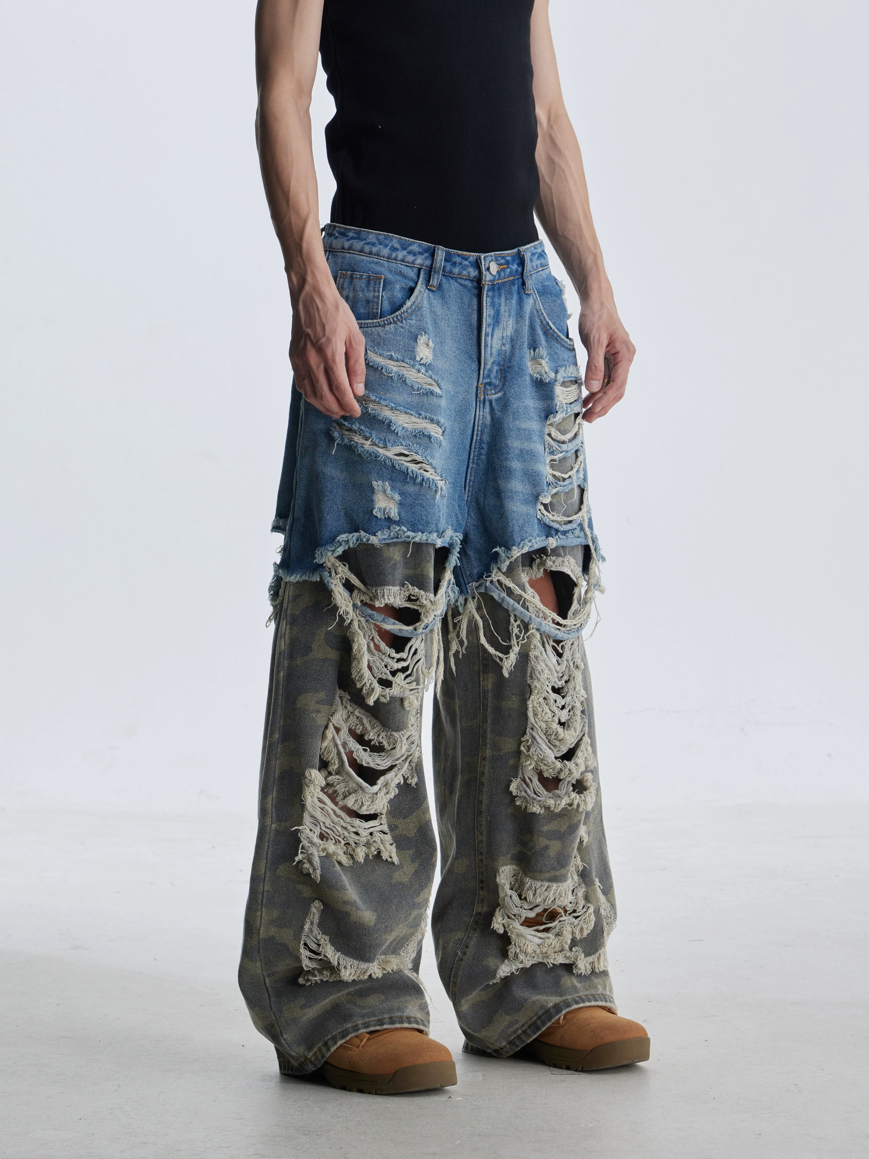 These deconstructed patchwork camo jeans from Sanhoostudio feature a unique layered fake two-piece effect, distressed ripped accents, and a loose straight-leg silhouette. Combining vintage inspiration with edgy high street aesthetics, they are perfect for streetwear lovers seeking comfort, individuality.