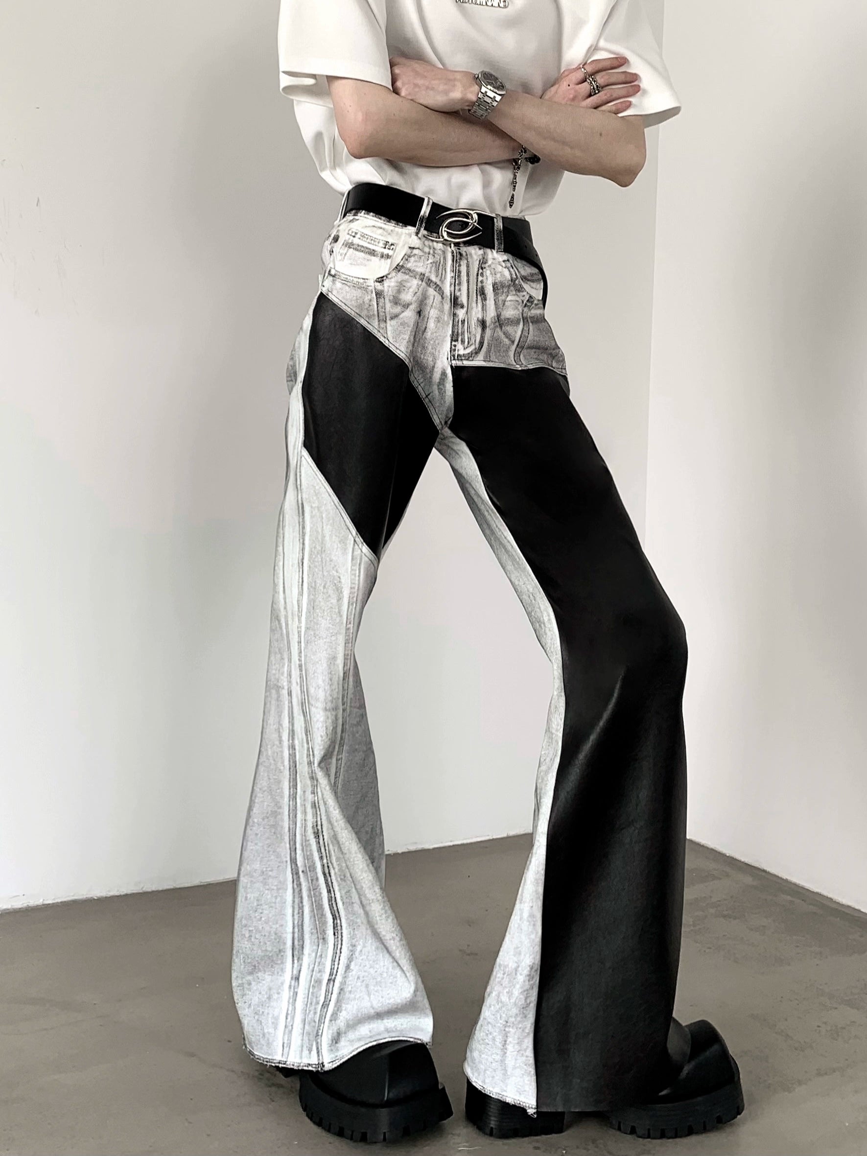 The Sanhoostudio distressed off-white jeans combine premium leather patchwork with a subtle flared cut. Their faded finish adds a rugged vintage vibe, while the unique detailing enhances versatility, making them a must-have for bold, high-fashion urban wardrobes.