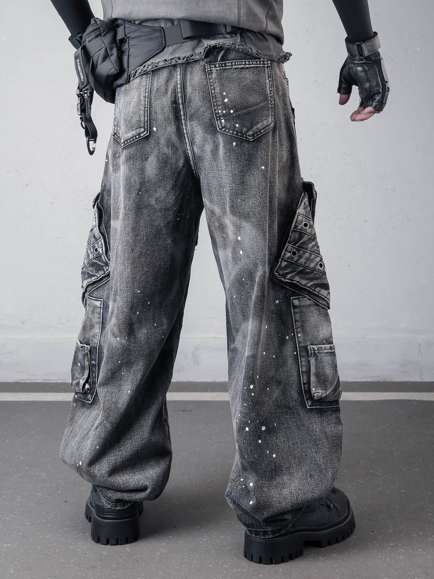 Sanhoostudio denim pants featuring paint splatter finish, multi-pocket design, and wide leg silhouette. Built for bold streetwear styling with a rugged aesthetic, functional details, and comfortable everyday wear.