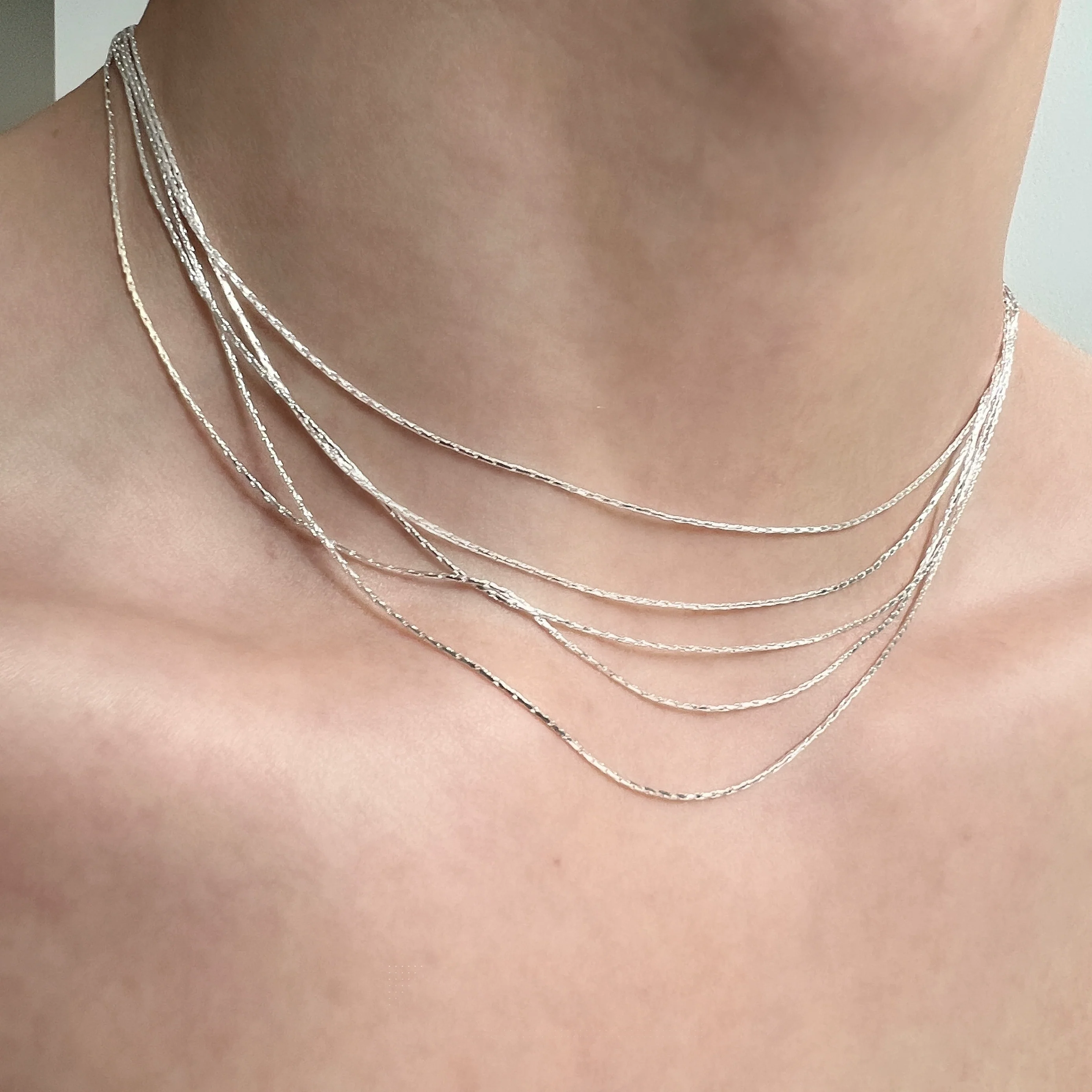 Sanhoostudio’s silver multi-layer thin chain necklace delivers delicate sparkle and romantic bling—perfect for layering, special occasions, and elevating everyday outfits with refined shine.