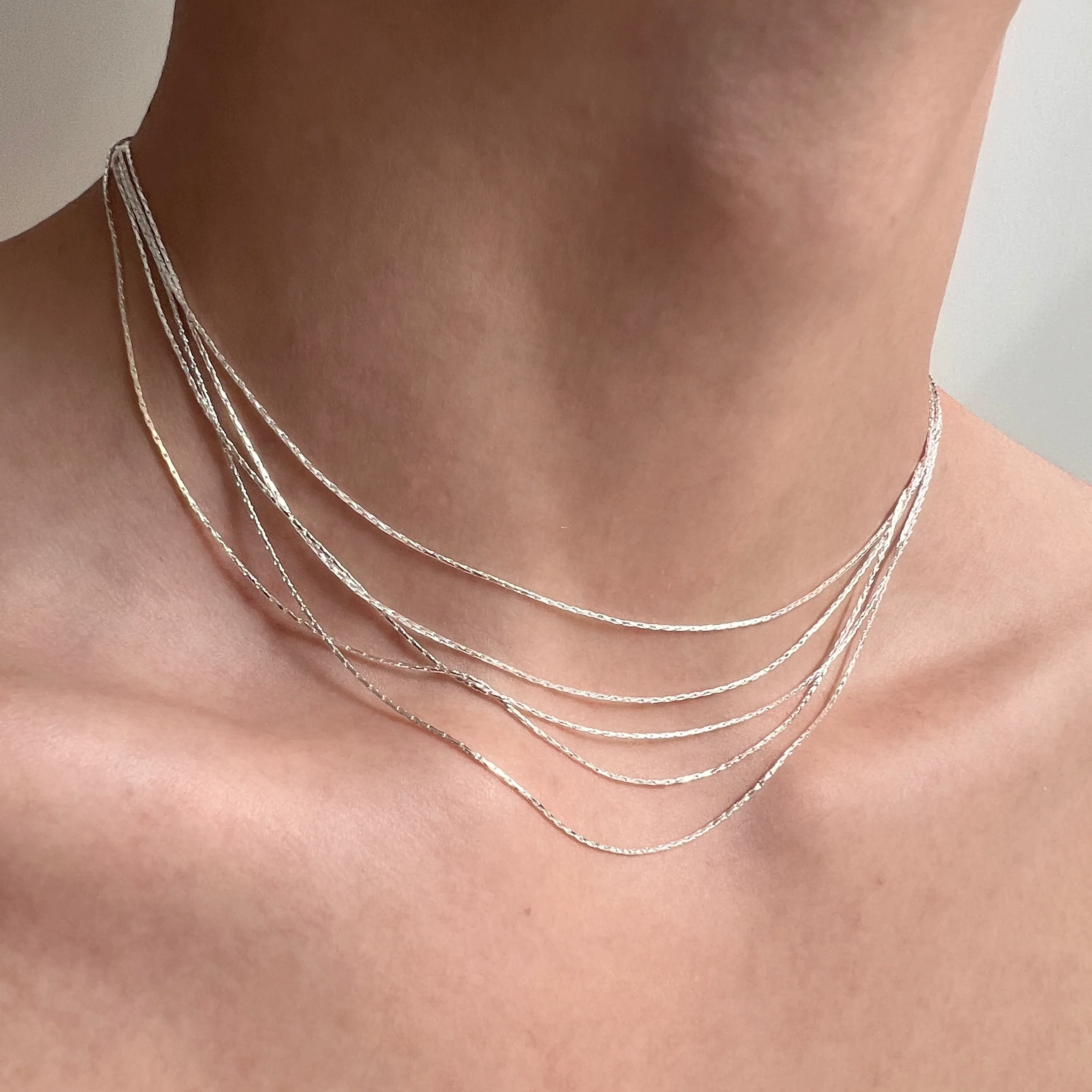 Sanhoostudio’s silver multi-layer thin chain necklace delivers delicate sparkle and romantic bling—perfect for layering, special occasions, and elevating everyday outfits with refined shine.