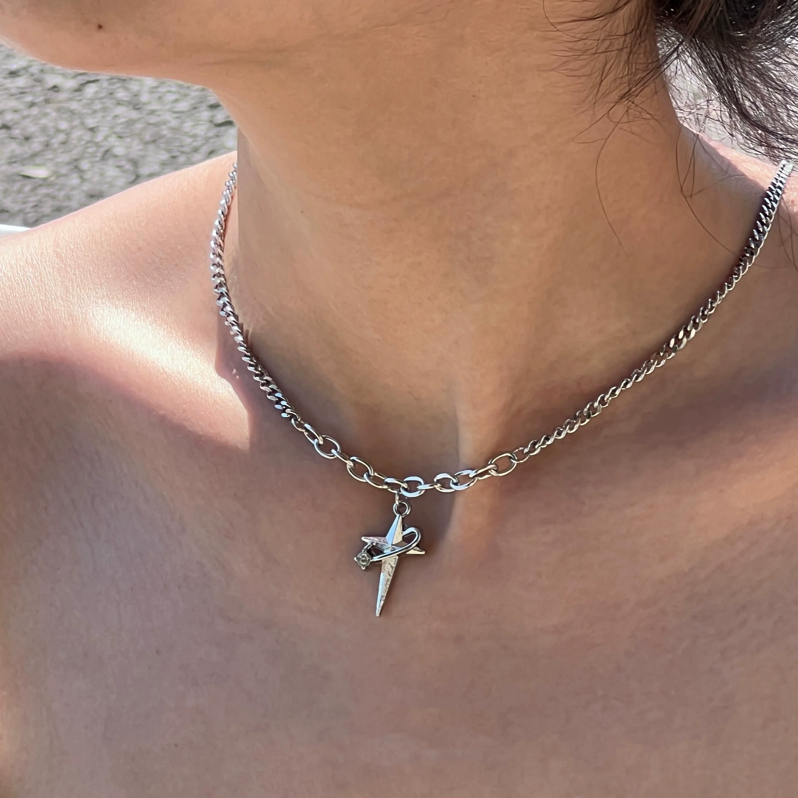 Sanhoostudio’s star cross wrap titanium necklace wraps gothic motifs into layered titanium design—sturdy, stylish, and ideal for dark-luxe streetwear and layered accessorizing.