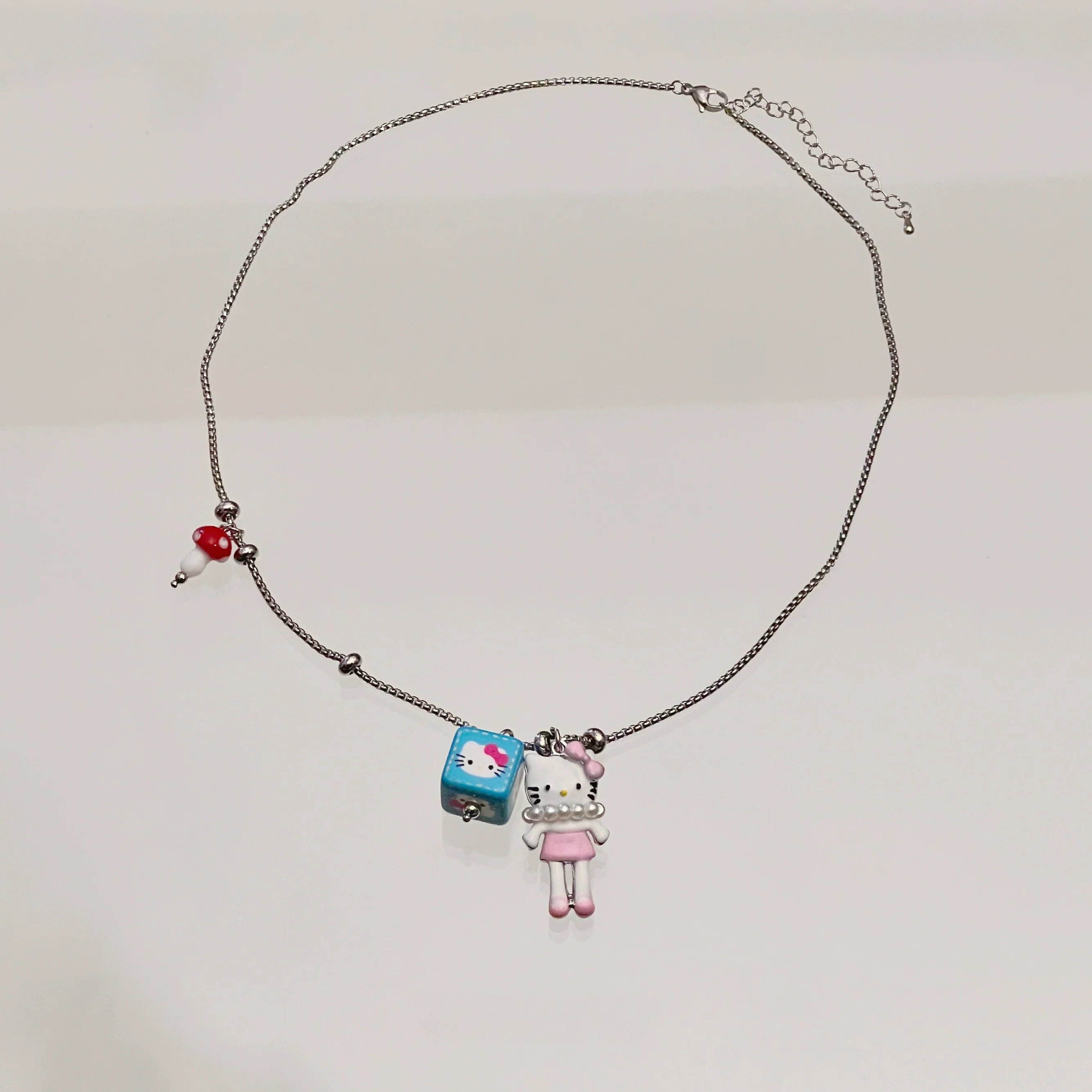 Sanhoostudio’s cute KT cat cartoon necklace adds a fun, youthful touch to any outfit. Designed for playful streetwear and kawaii-inspired fashion, it’s perfect for bold and quirky style statements.