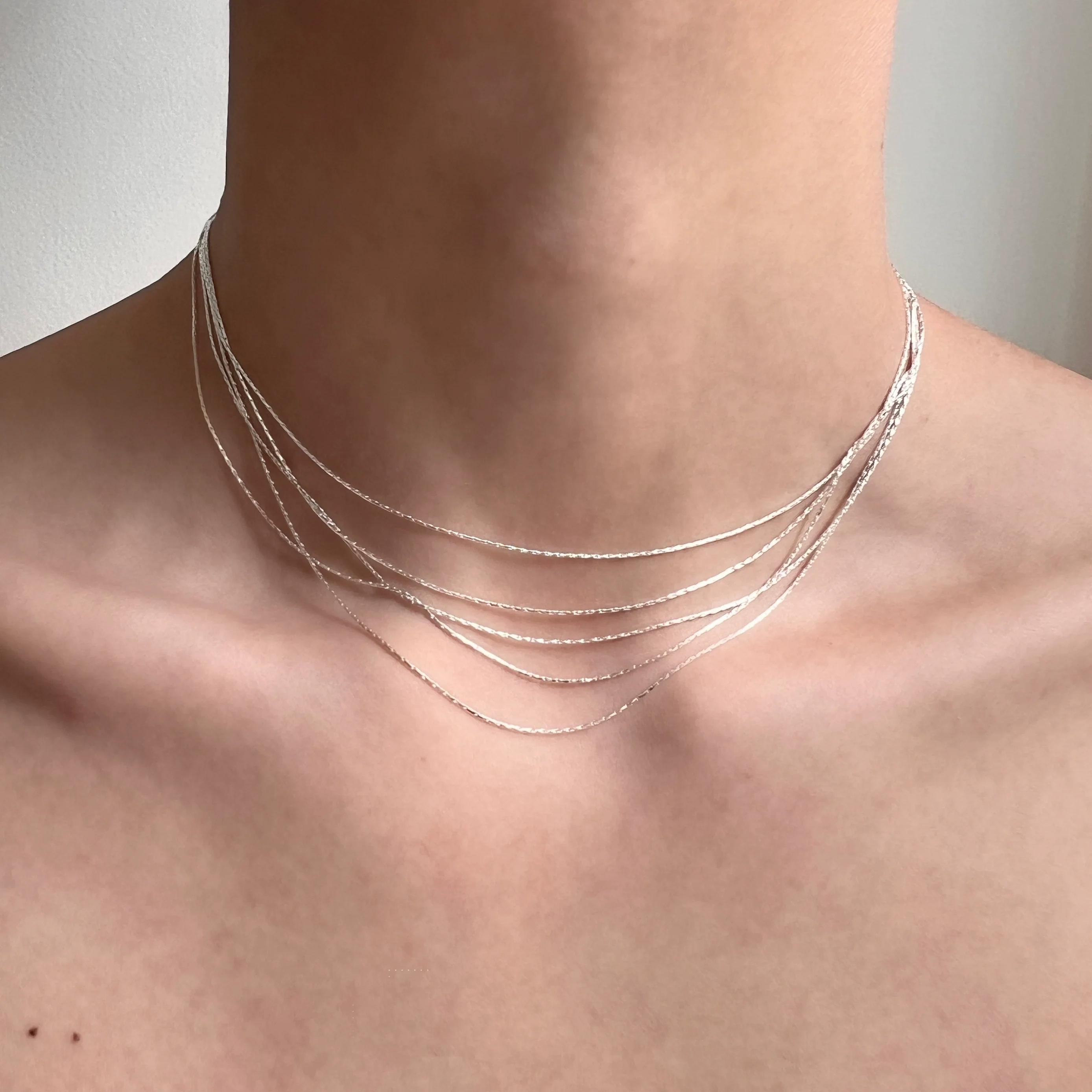 Sanhoostudio’s silver multi-layer thin chain necklace delivers delicate sparkle and romantic bling—perfect for layering, special occasions, and elevating everyday outfits with refined shine.