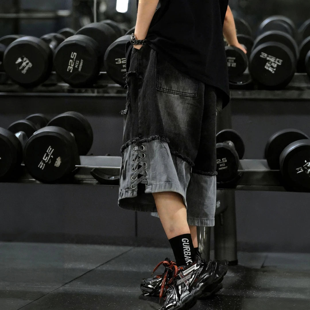Sanhoostudio sleeveless T-shirt featuring distressed detailing, red spray-print artwork, and a relaxed oversized fit. Designed for summer streetwear styling with breathable comfort and a bold urban aesthetic.