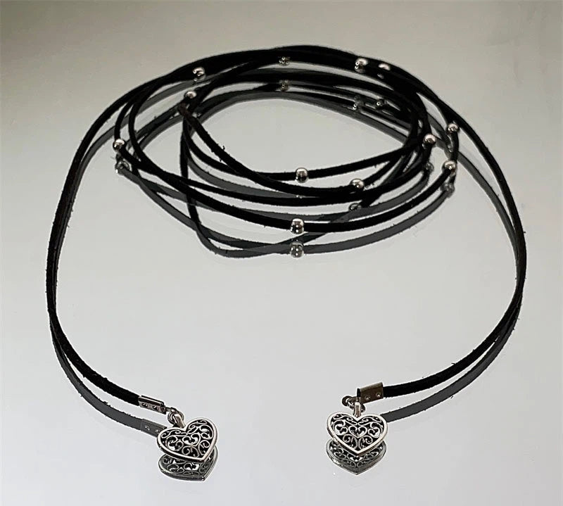 Express effortless Bohemian charm with Sanhoostudio’s silver heart wrap necklace. The long leather cord design combines vintage texture with modern simplicity.