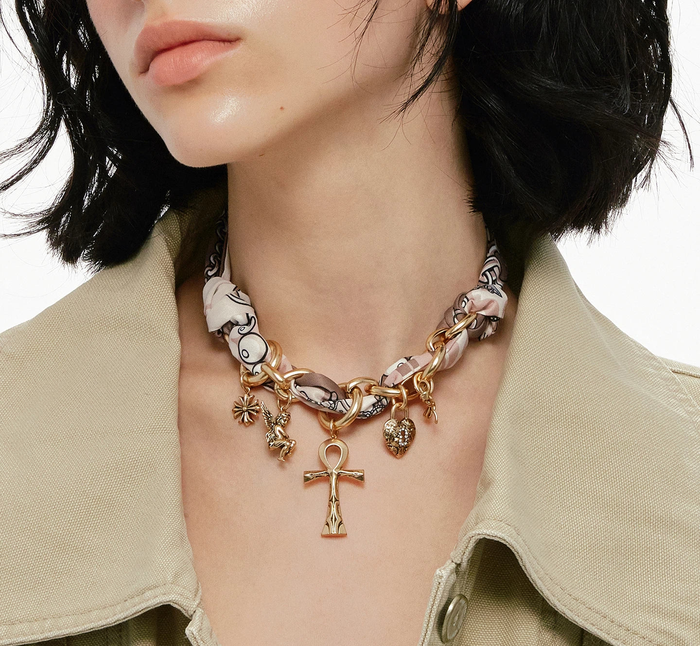 A bold blend of textures — Sanhoostudio’s silk scarf Ankh necklace brings soft femininity and edgy charm into one elegant design.