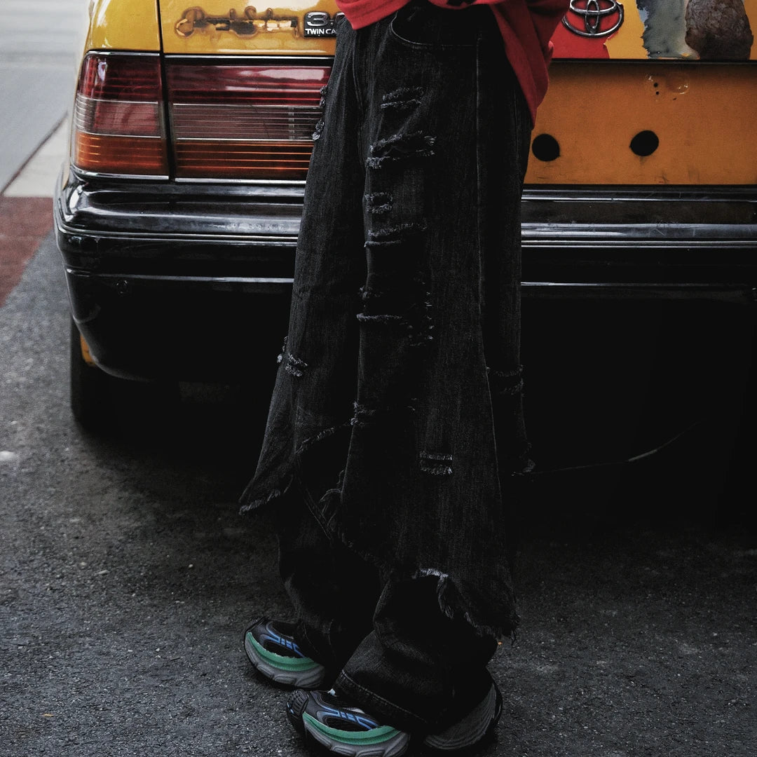 Two-layer distressed cargo pants featuring frayed edges, hip-hop street detailing, and a wide-leg silhouette with strong attitude.