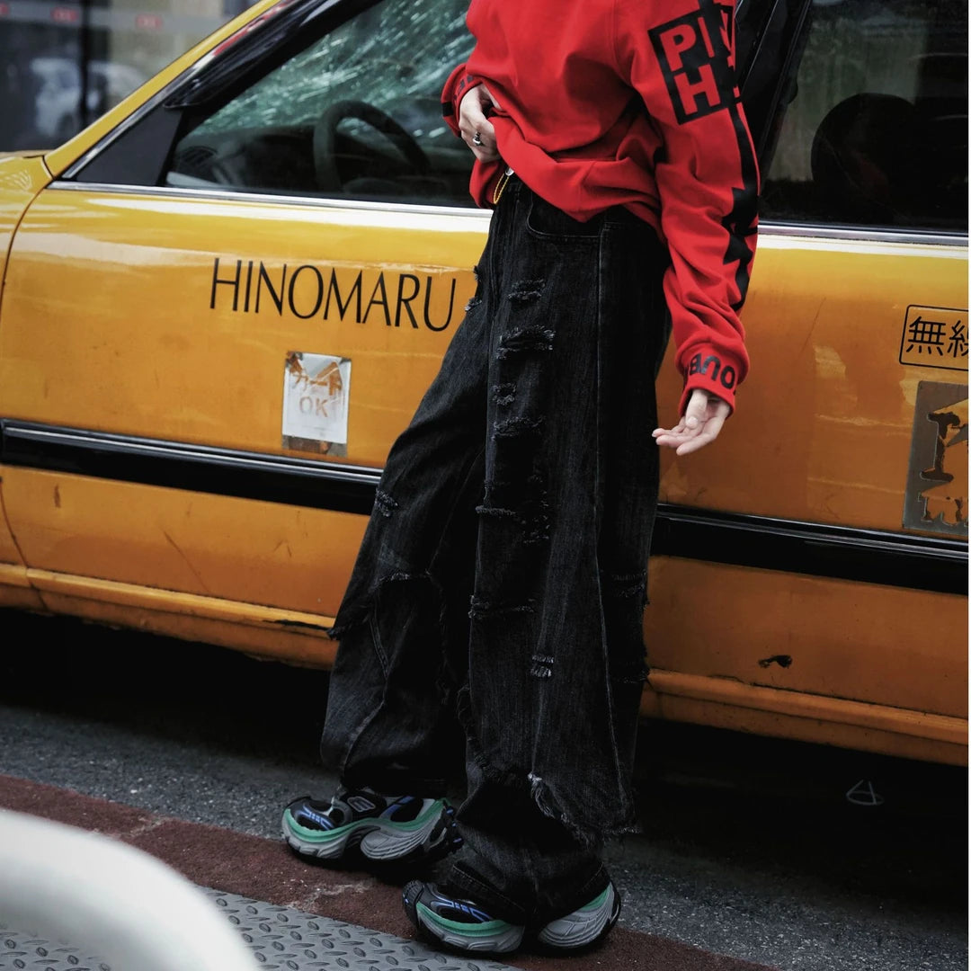 Two-layer distressed cargo pants featuring frayed edges, hip-hop street detailing, and a wide-leg silhouette with strong attitude.