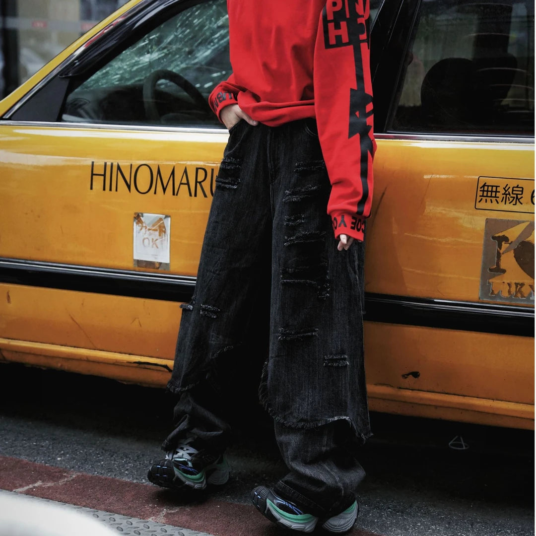 Two-layer distressed cargo pants featuring frayed edges, hip-hop street detailing, and a wide-leg silhouette with strong attitude.