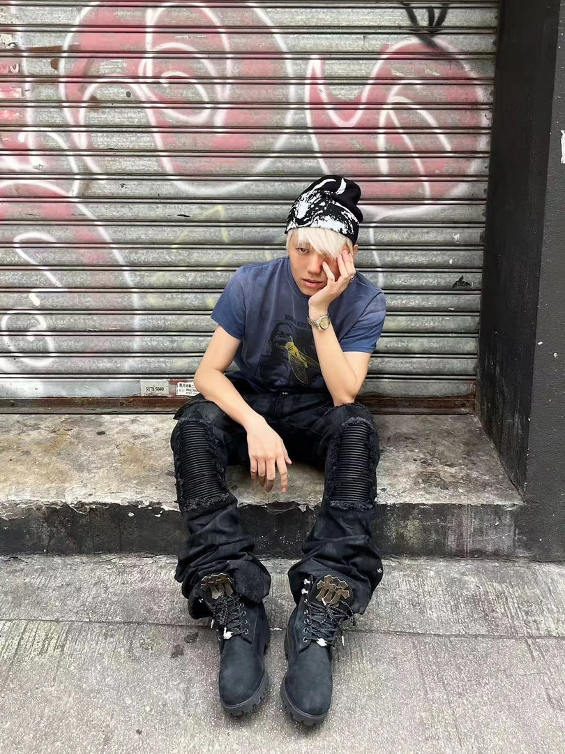 Sanhoostudio wax-finished denim pants made from breathable 100% cotton. Designed with curved cutting, distressed paneling, subtle stretch feel, and straight-leg silhouette for a bold dark street aesthetic.