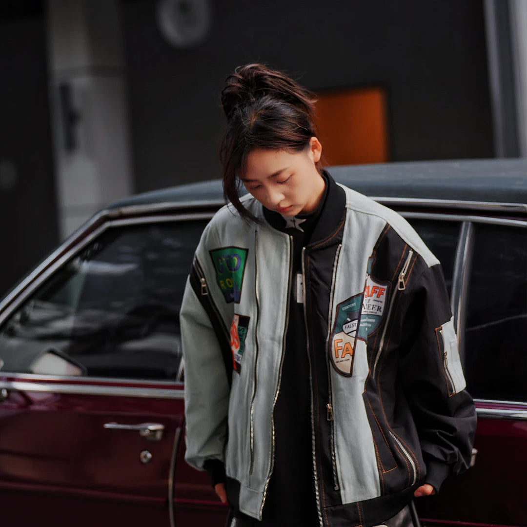 Sanhoostudio vintage colorblock denim varsity jacket with washed texture and relaxed hooded fit. A unisex streetwear outerwear piece for everyday layering.