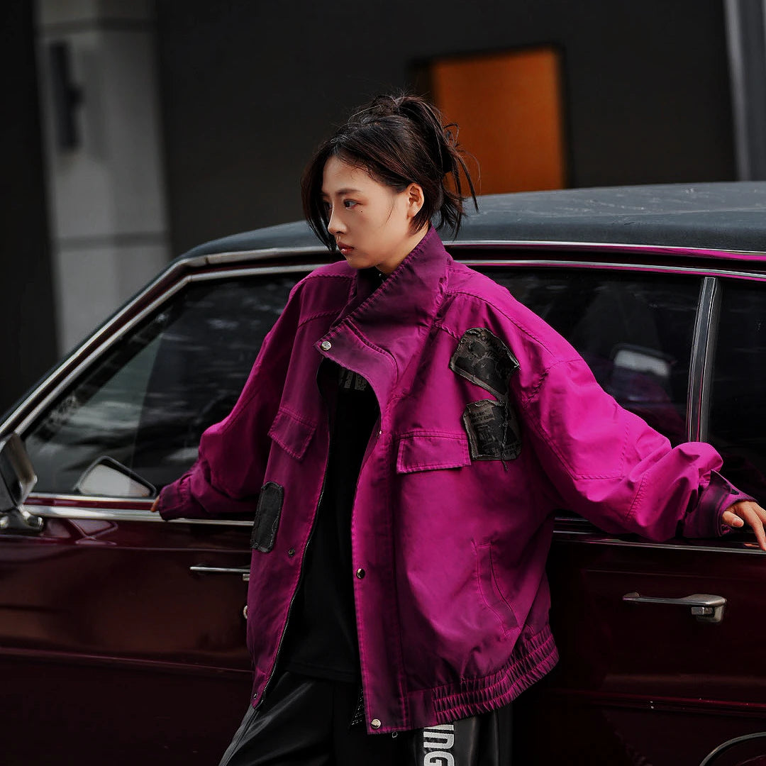 Sanhoostudio cropped bomber jacket with patch embroidery and wrinkle-resistant cotton fabric. Inspired by American varsity culture and streetwear aesthetics.