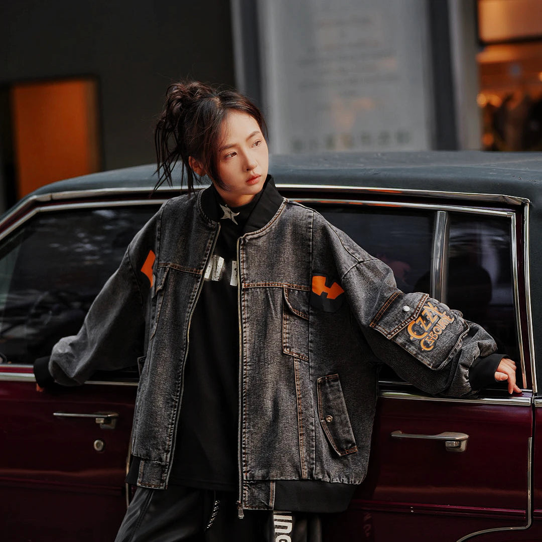 Sanhoostudio washed denim varsity jacket featuring contrast paneling and relaxed fit. A timeless unisex jacket for everyday streetwear layering.