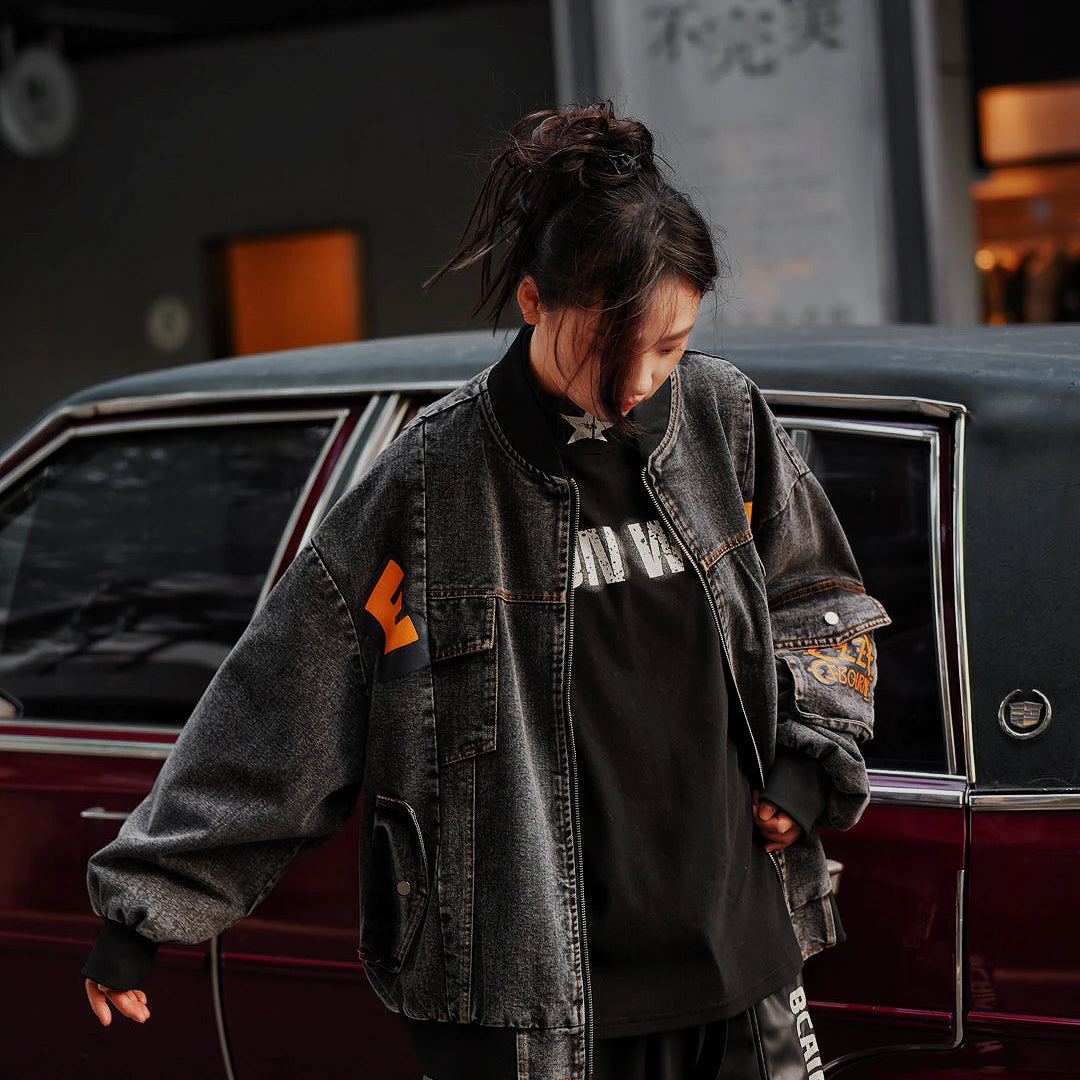 Sanhoostudio washed denim varsity jacket featuring contrast paneling and relaxed fit. A timeless unisex jacket for everyday streetwear layering.