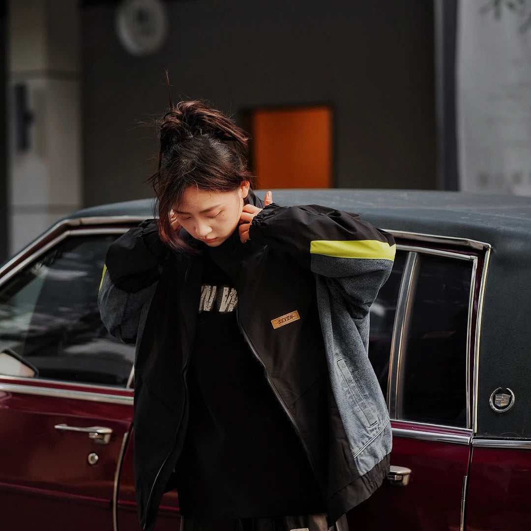 Sanhoostudio washed denim varsity jacket featuring contrast paneling and relaxed fit. A timeless unisex jacket for everyday streetwear layering.