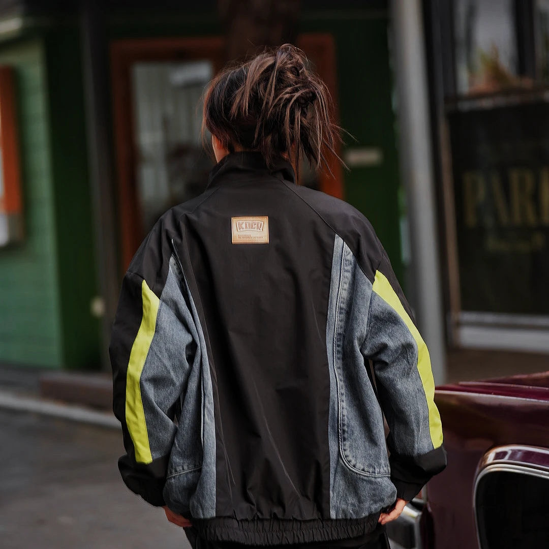 Sanhoostudio washed denim varsity jacket featuring contrast paneling and relaxed fit. A timeless unisex jacket for everyday streetwear layering.