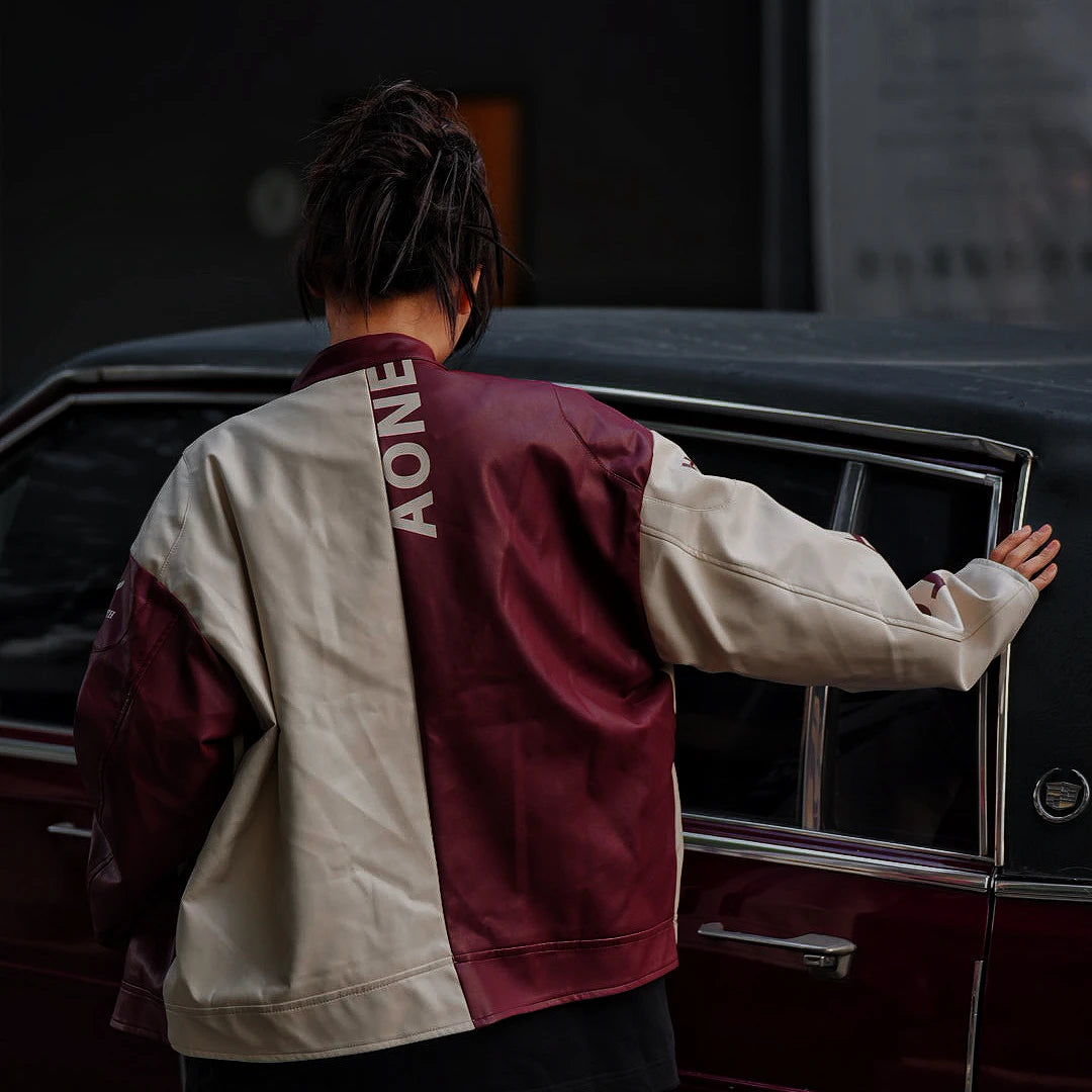 Sanhoostudio washed denim varsity jacket featuring contrast paneling and relaxed fit. A timeless unisex jacket for everyday streetwear layering.