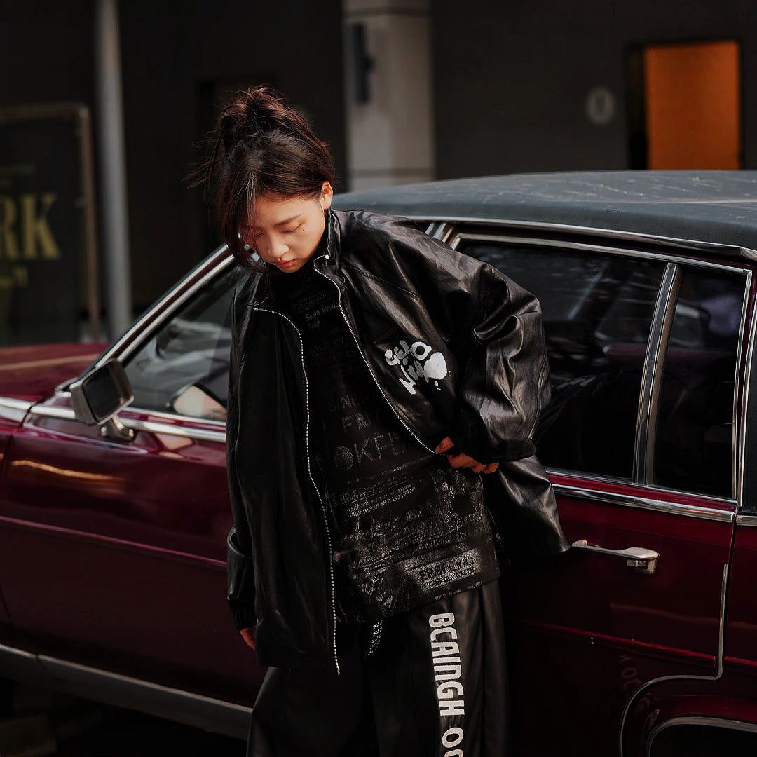 Sanhoostudio washed denim varsity jacket featuring contrast paneling and relaxed fit. A timeless unisex jacket for everyday streetwear layering.