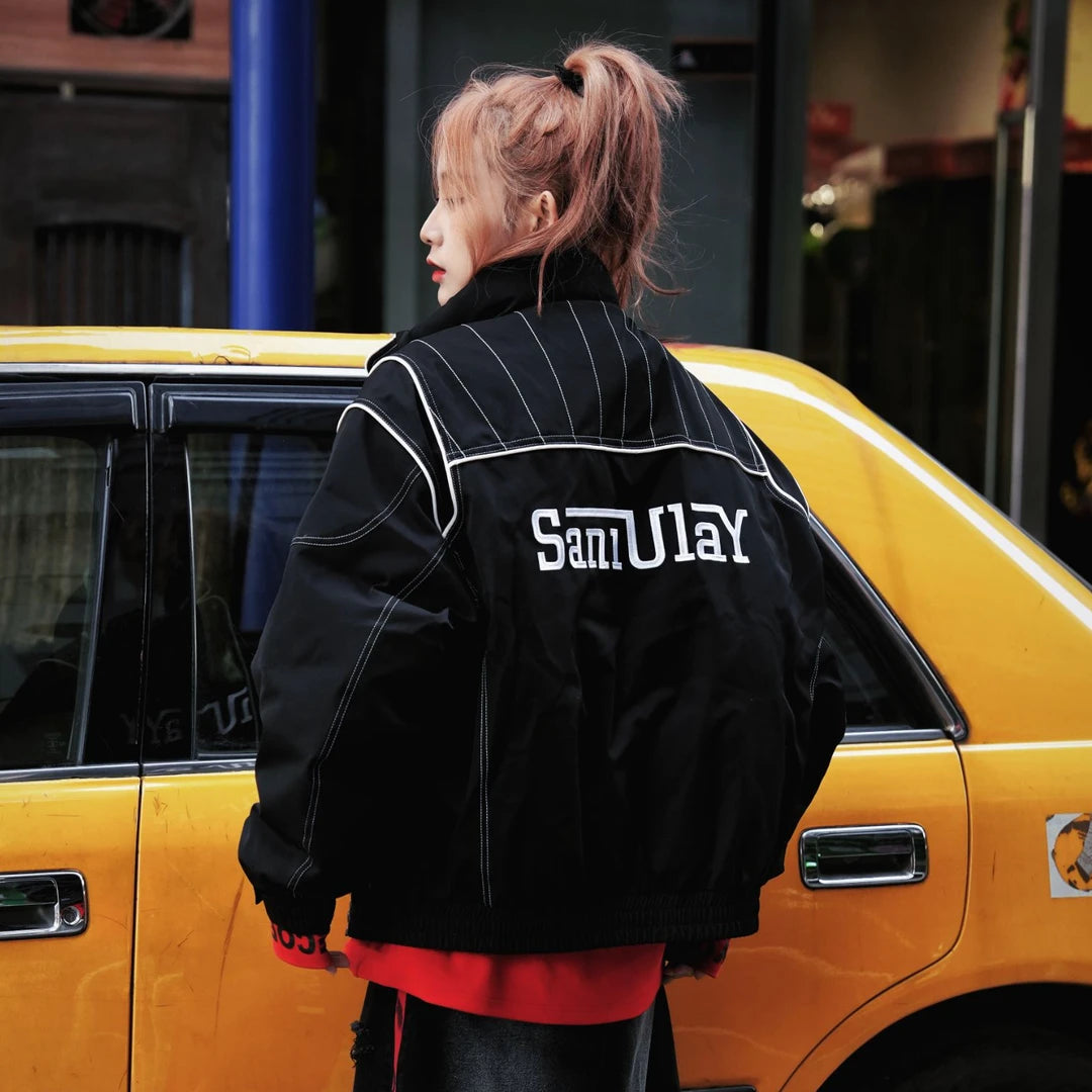 Sanhoostudio down jacket featuring letter embroidery, colorblock design, and white duck down filling. A loose-fit streetwear jacket inspired by biker style for winter wear.
