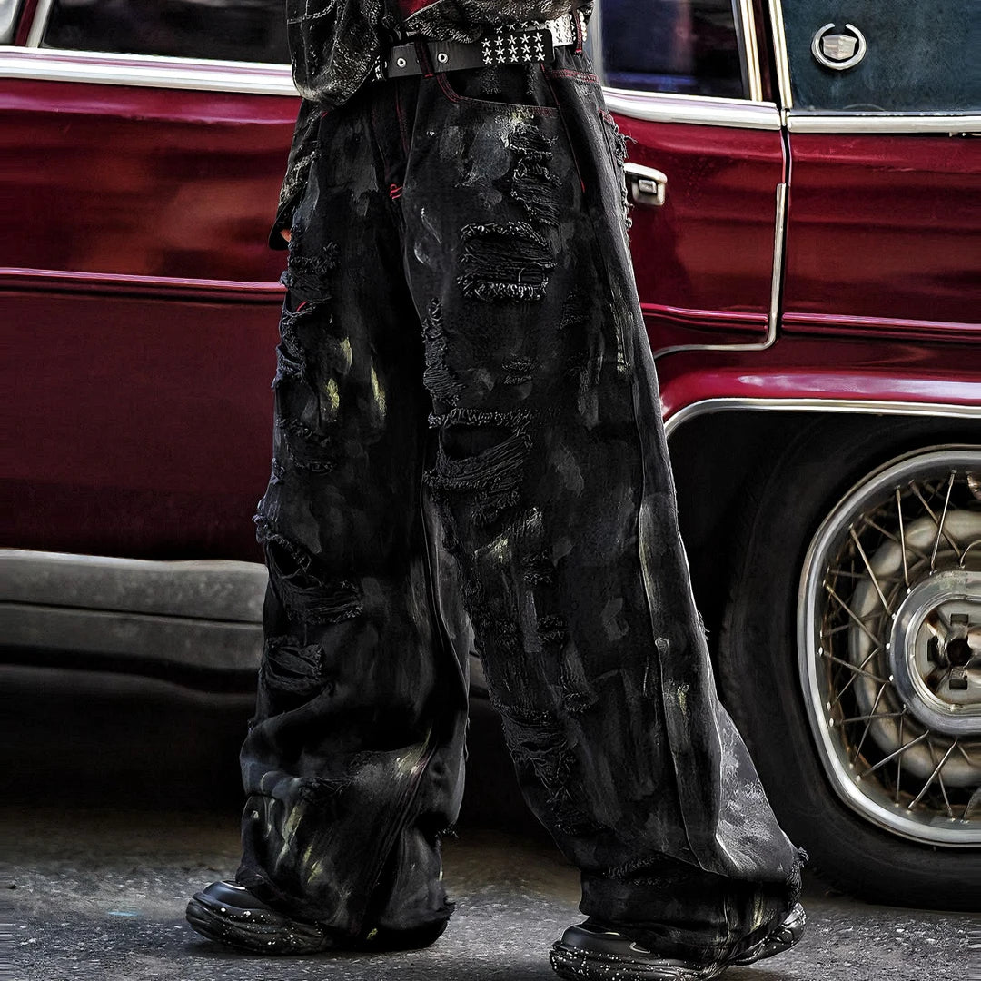 Sanhoostudio heavyweight denim pants featuring embroidery, graffiti details, and washed distressed texture. Designed with patchwork construction for bold unisex streetwear styling.