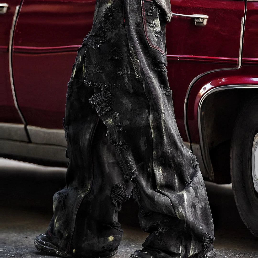 Sanhoostudio heavyweight denim pants featuring embroidery, graffiti details, and washed distressed texture. Designed with patchwork construction for bold unisex streetwear styling.