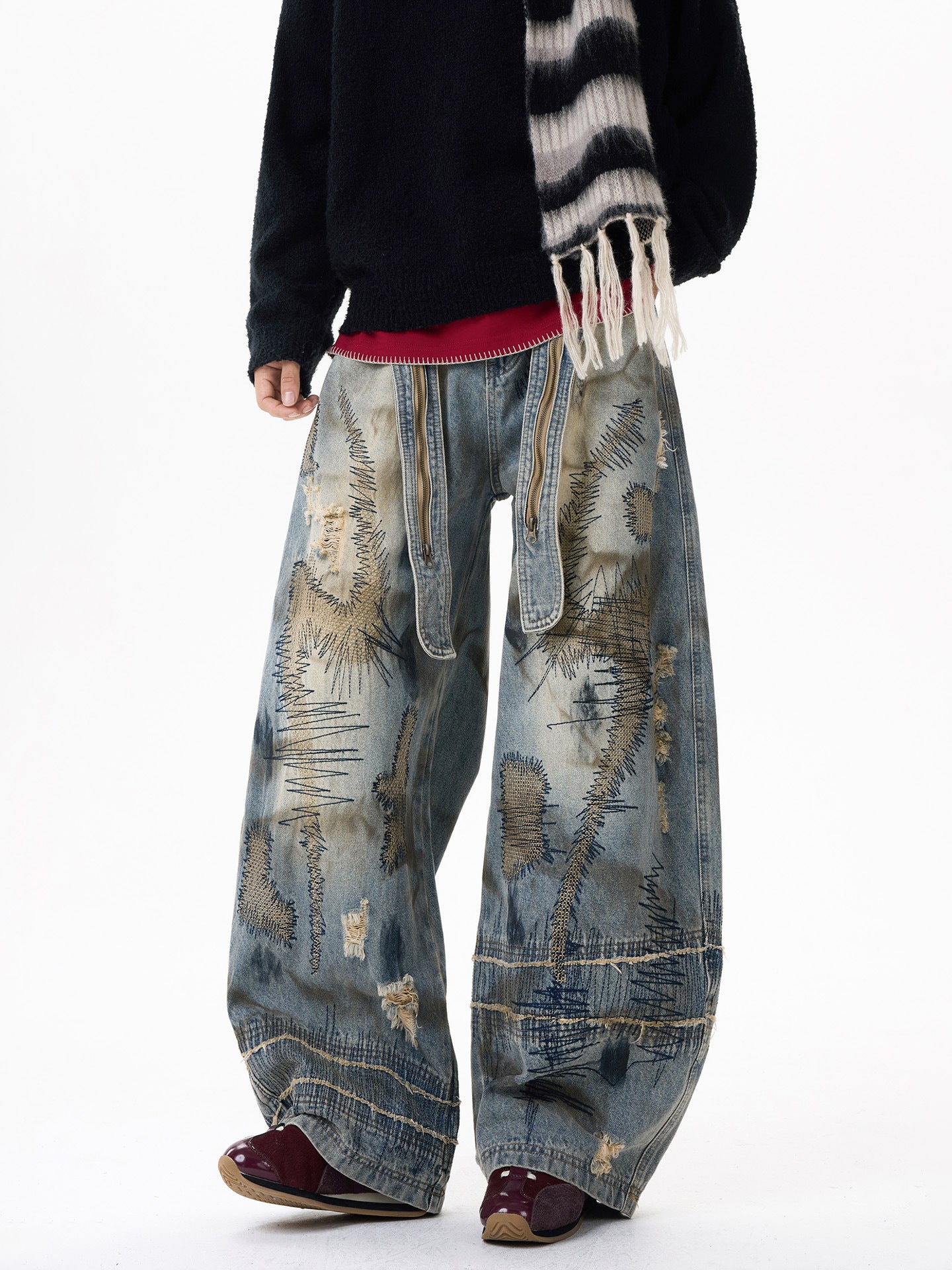 Sanhoostudio wide leg denim pants featuring distressed wash, heavy embroidery, and wasteland-inspired design. Built with a loose fit silhouette for bold streetwear styling.