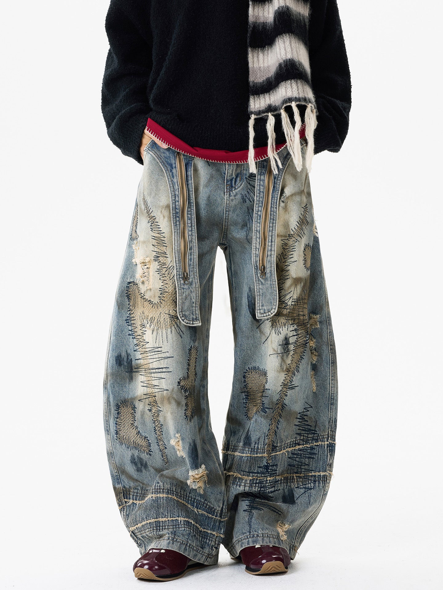 Sanhoostudio wide leg denim pants featuring distressed wash, heavy embroidery, and wasteland-inspired design. Built with a loose fit silhouette for bold streetwear styling.