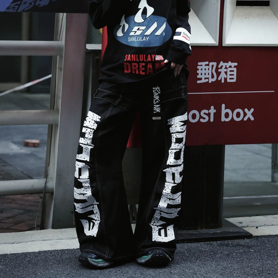 Sanhoostudio denim pants featuring scythe-cut silhouette and letter print design for modern streetwear styling.