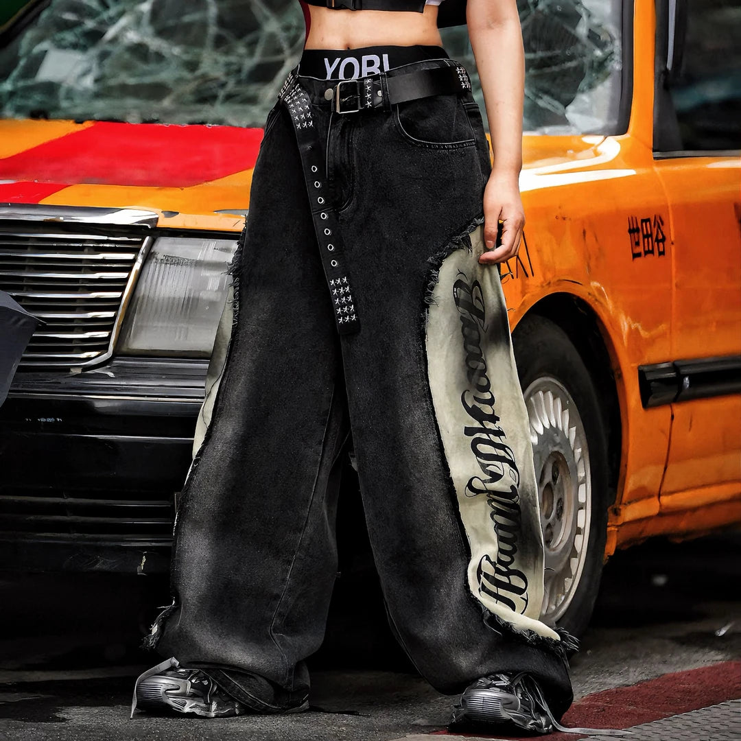 Sanhoostudio denim pants featuring scythe-cut silhouette, distressed wash, and patchwork construction. Designed with a wide leg fit for bold streetwear styling and everyday versatility.