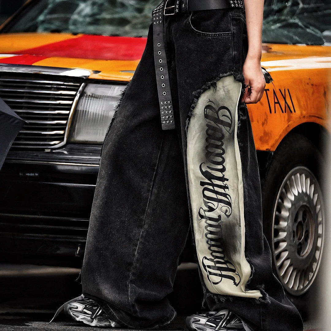 Sanhoostudio denim pants featuring scythe-cut silhouette, distressed wash, and patchwork construction. Designed with a wide leg fit for bold streetwear styling and everyday versatility.