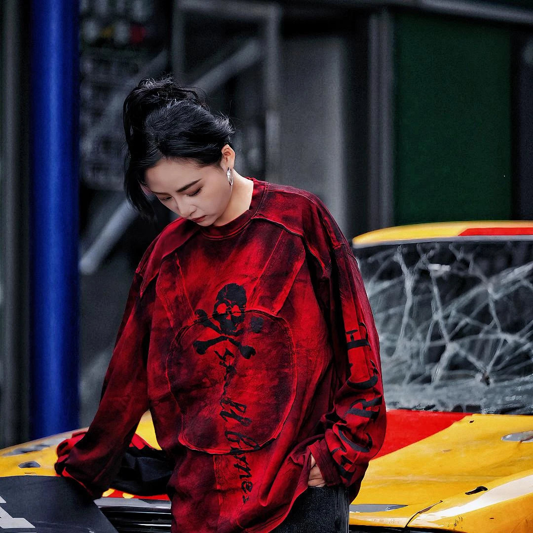 Sanhoostudio long sleeve T-shirt featuring graffiti print, patchwork construction, and relaxed fit. A versatile streetwear piece for layering and daily wear.