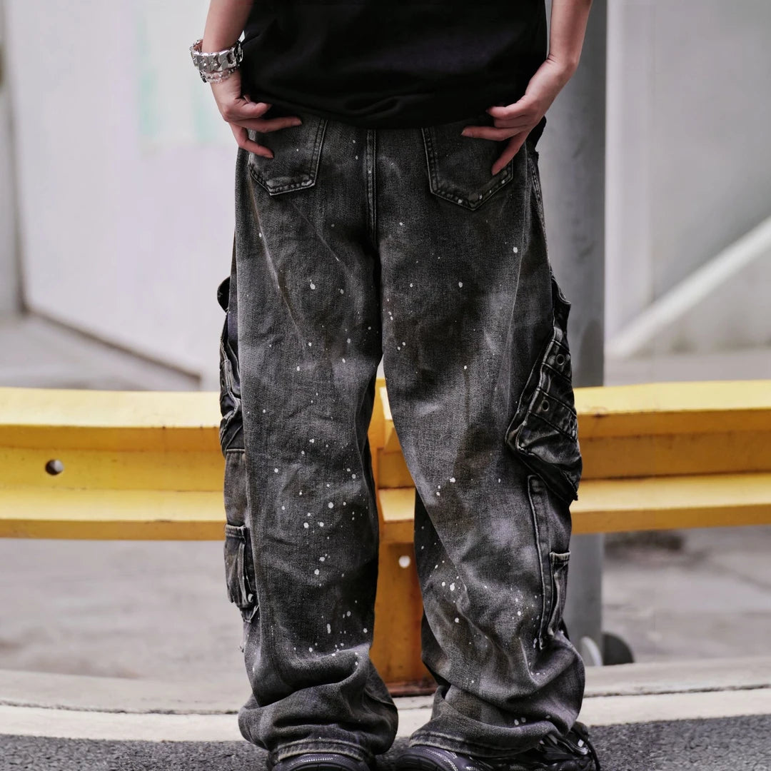 Sanhoostudio wide leg cargo pants featuring distressed wash, paint splatter details, and multi-pocket design. Built for functional streetwear styling with durability, comfort, and bold urban aesthetics.
