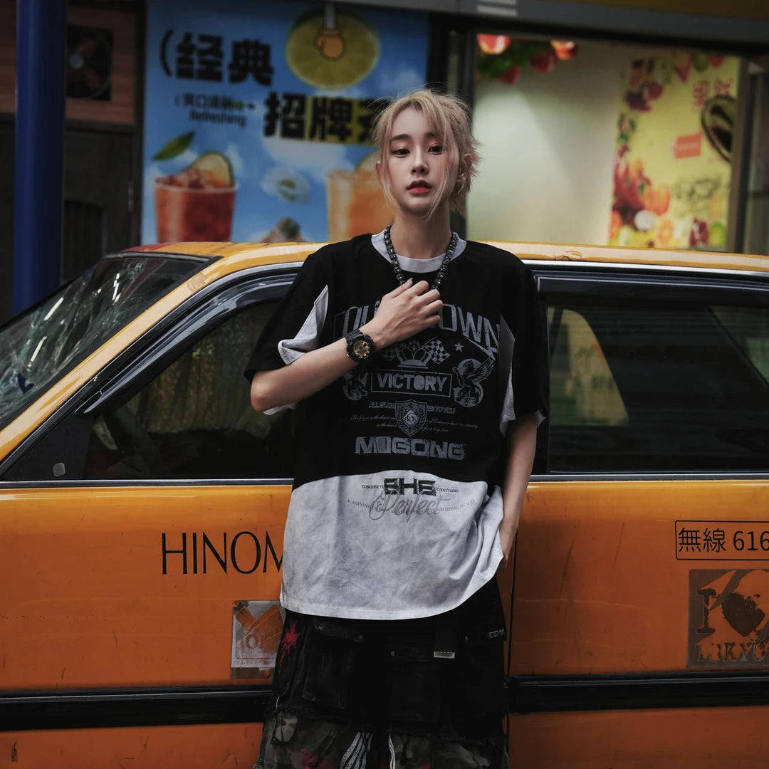 Sanhoostudio short sleeve T-shirt featuring racing-inspired design, patchwork details, and distressed wash. Designed for bold streetwear styling with comfort and breathable summer wear.