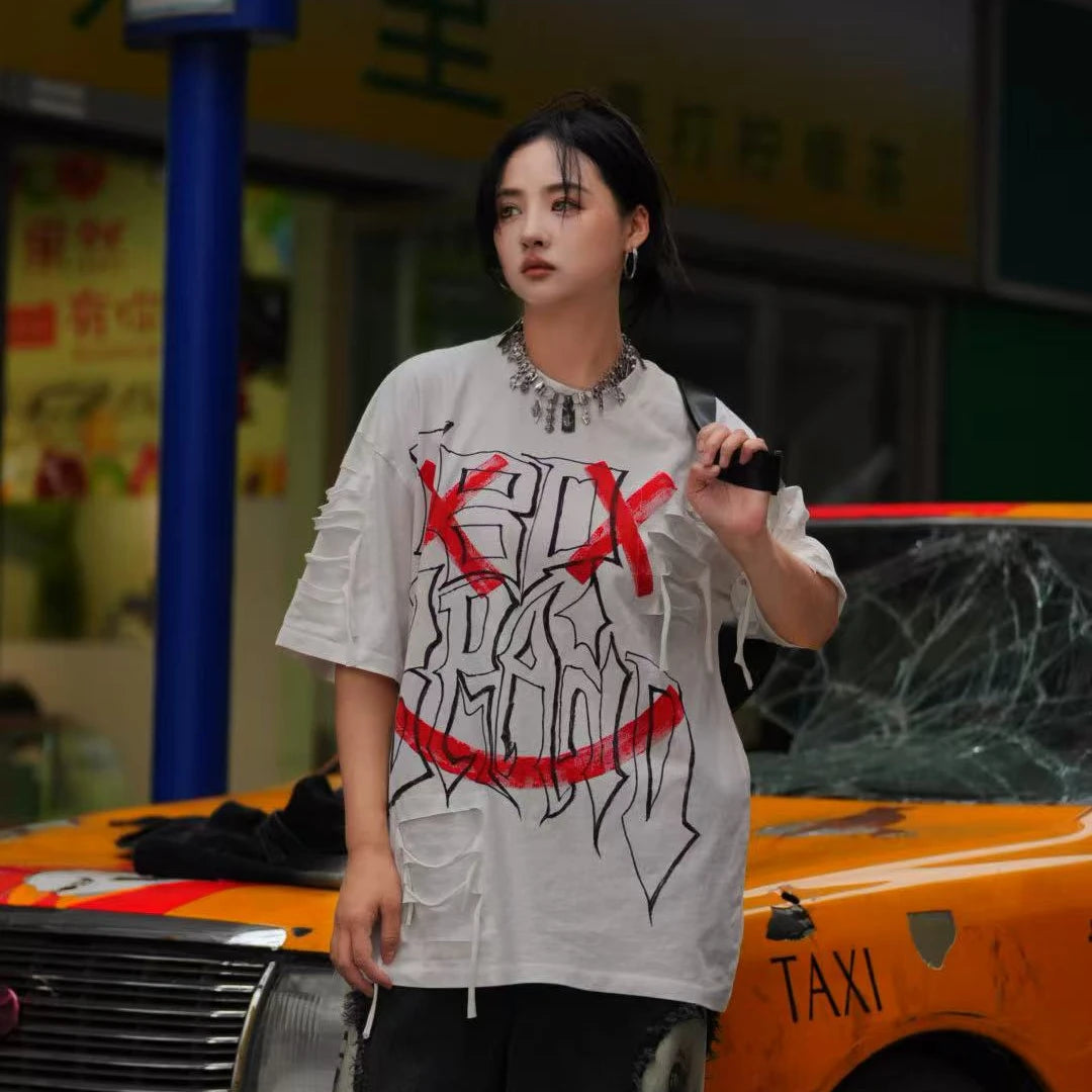 Sanhoostudio short sleeve T-shirt featuring graffiti print, tie dye finish, and patchwork design with an oversized fit silhouette. Designed for bold streetwear styling with breathable comfort, soft fabric feel, and versatile everyday wear for summer outfits.
