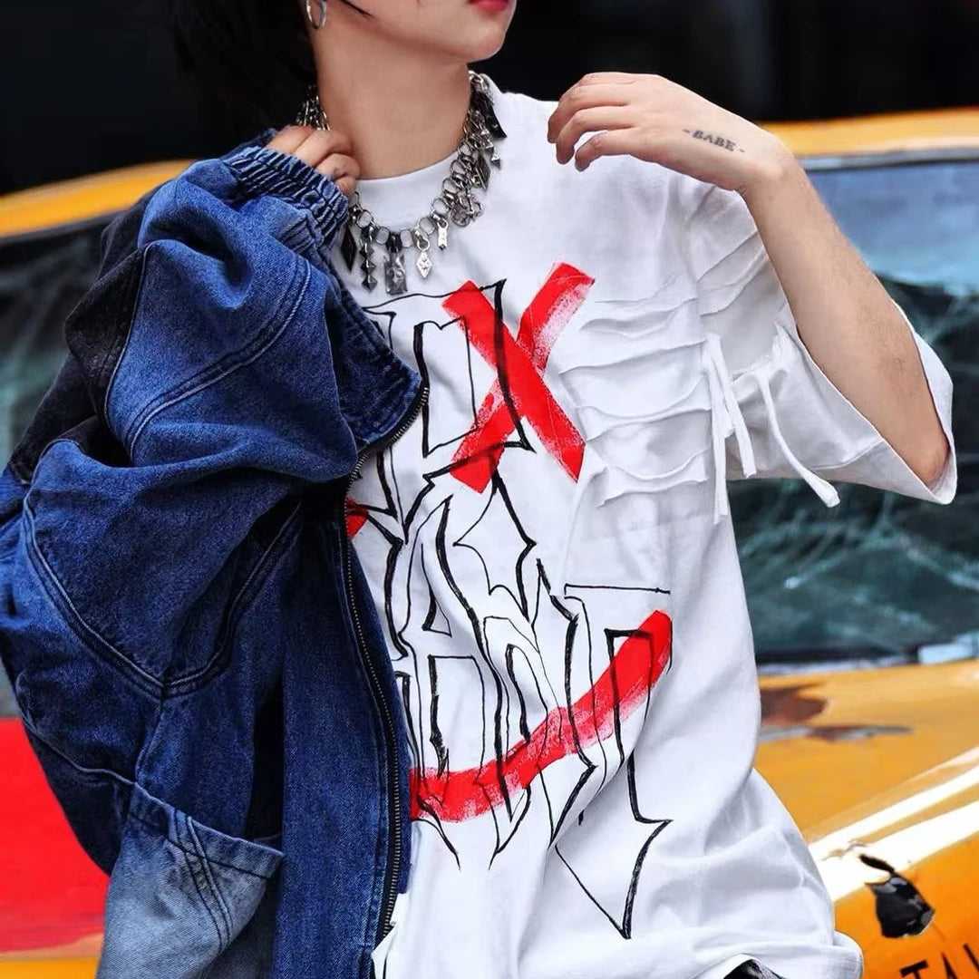 Sanhoostudio short sleeve T-shirt featuring graffiti print, tie dye finish, and patchwork design with an oversized fit silhouette. Designed for bold streetwear styling with breathable comfort, soft fabric feel, and versatile everyday wear for summer outfits.