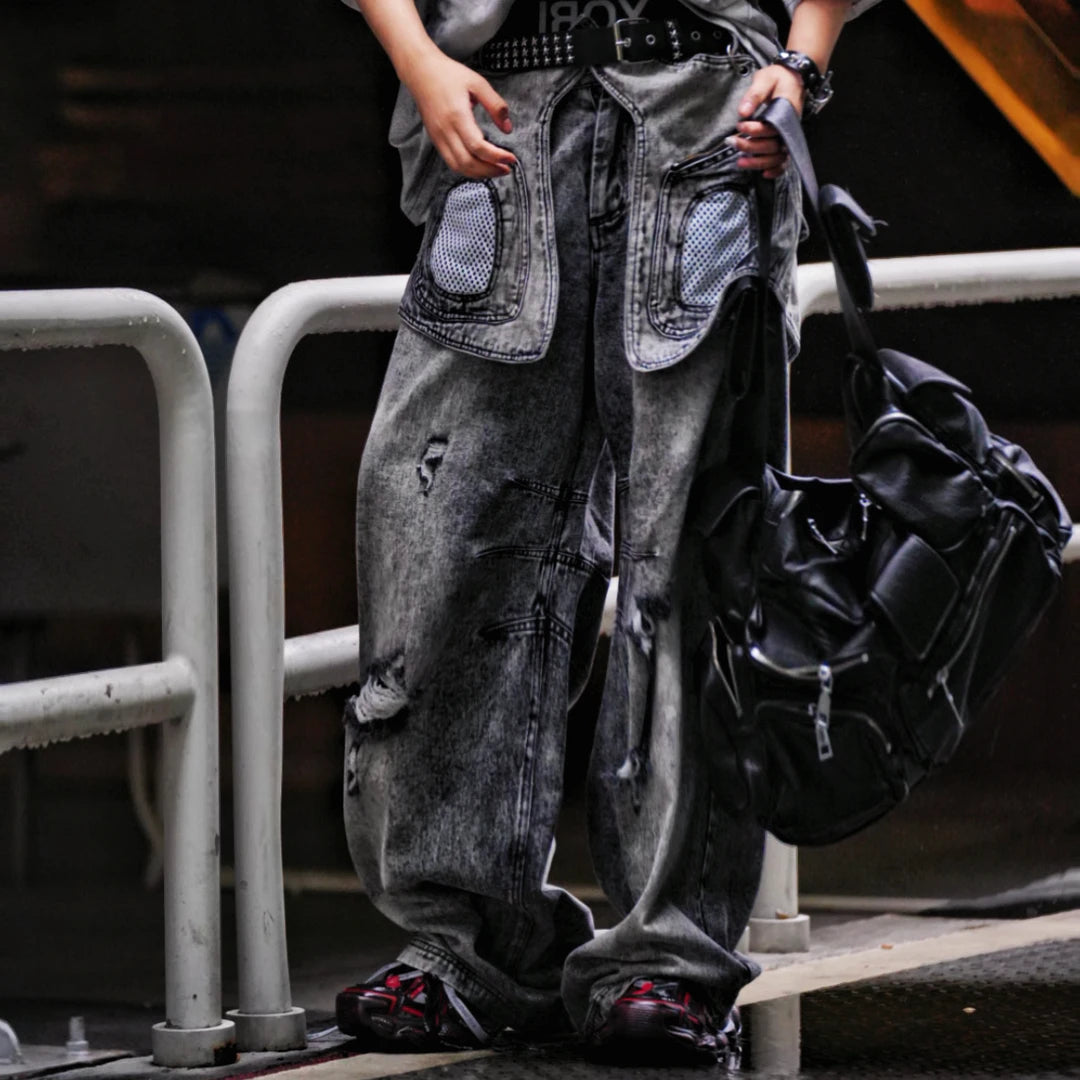 Sanhoostudio denim pants featuring layered patchwork construction, distressed wash finish, and detachable styling elements. Designed for bold streetwear outfits with relaxed comfort and unique visual structure.