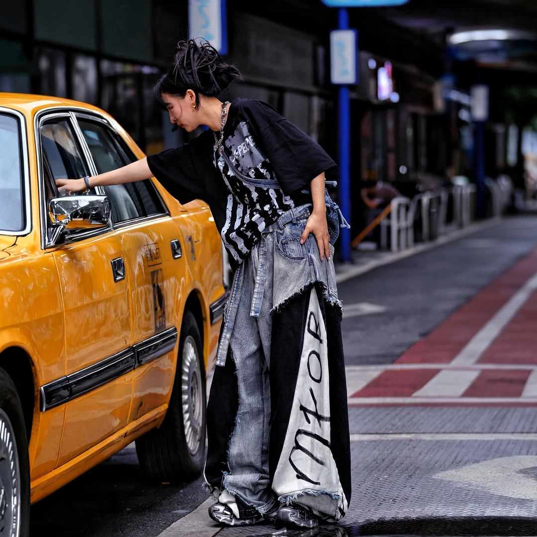 Sanhoostudio denim pants featuring distressed washed finish, patchwork detailing, and wide leg scythe-cut silhouette. Designed for modern streetwear styling with relaxed comfort and versatile everyday wear.