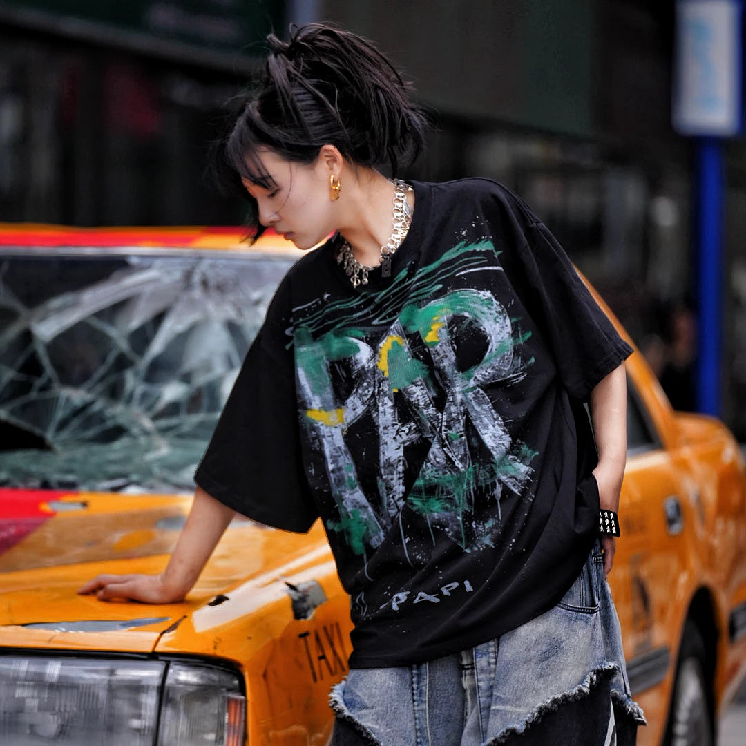 Sanhoostudio short sleeve T-shirt featuring graffiti spray print design and oversized fit silhouette. Designed for modern streetwear styling with breathable comfort, lightweight feel, and versatile everyday summer wear.