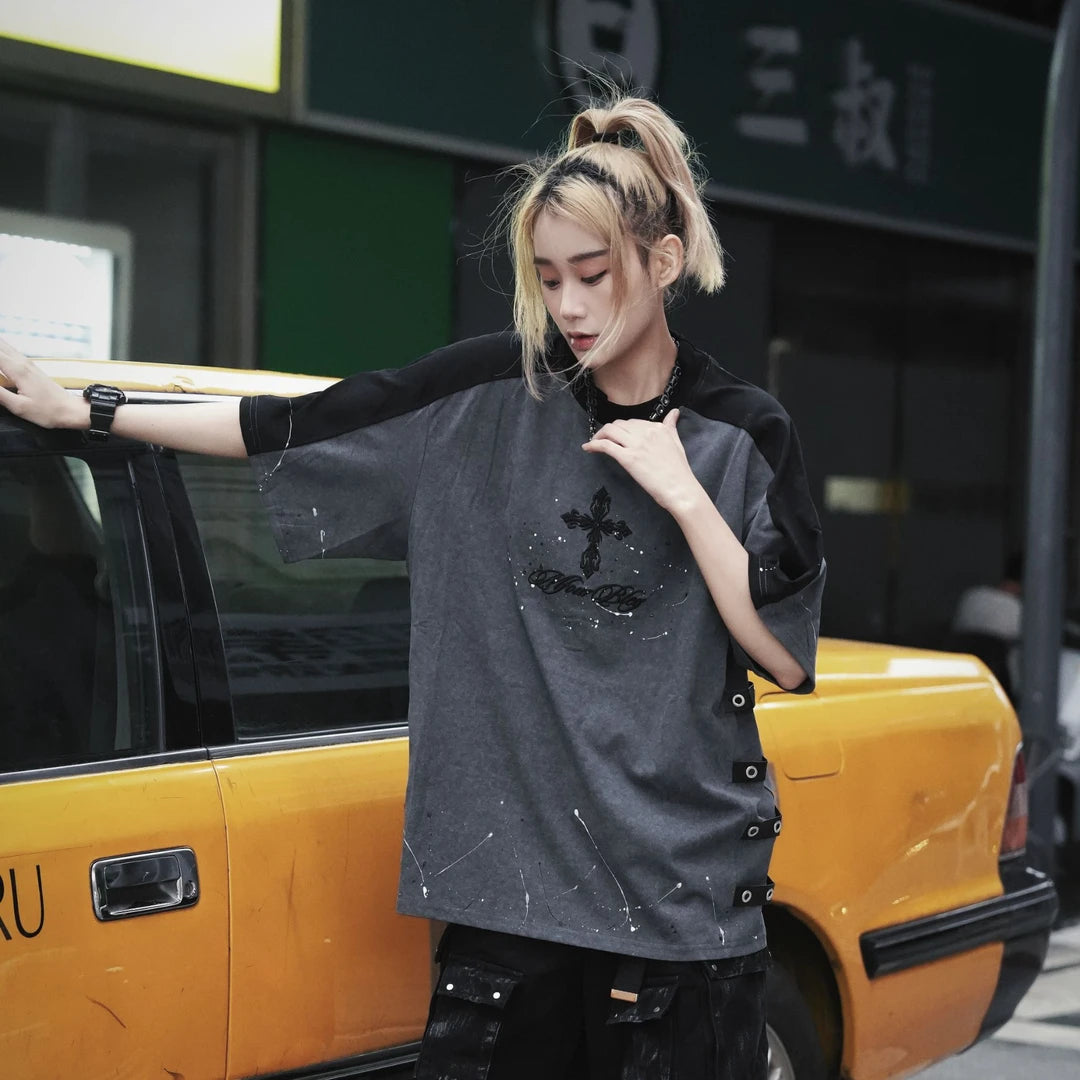 Sanhoostudio short sleeve T-shirt featuring cross embroidery, spray print artwork, and distressed detailing. Designed for dark streetwear styling with a relaxed fit and standout visual character.