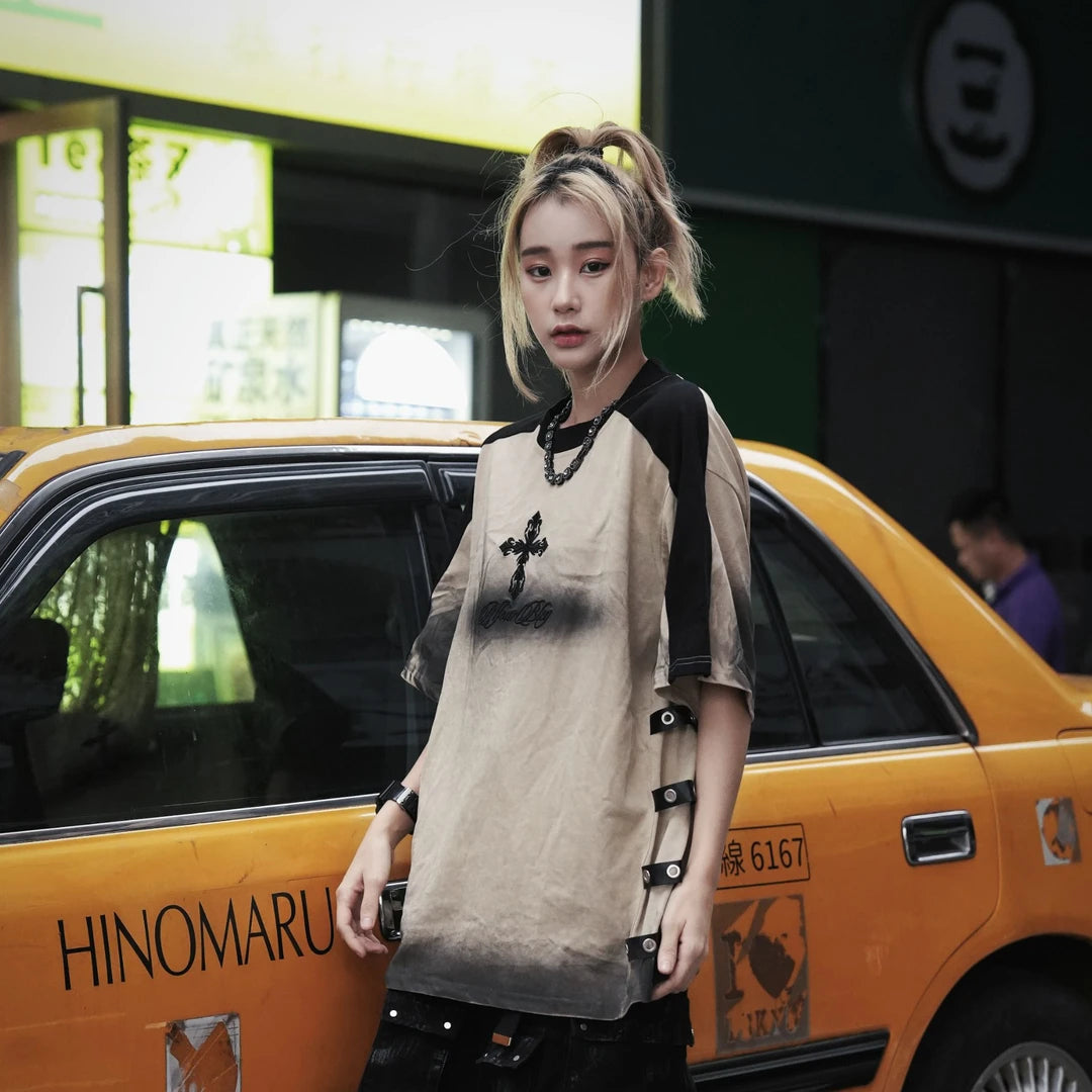 Sanhoostudio short sleeve T-shirt featuring cross embroidery, spray print artwork, and distressed detailing. Designed for dark streetwear styling with a relaxed fit and standout visual character.