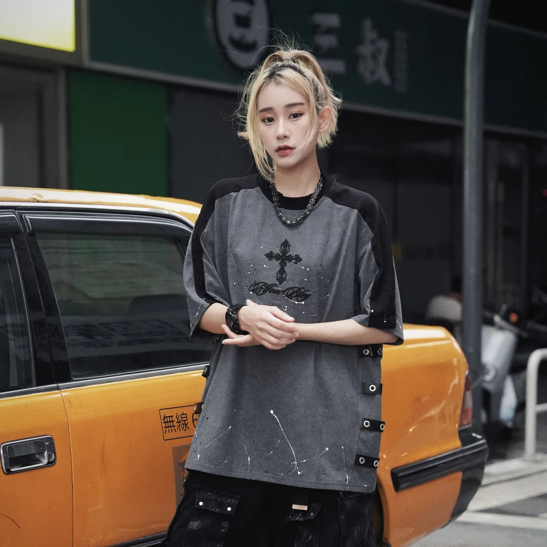Sanhoostudio short sleeve T-shirt featuring cross embroidery, spray print artwork, and distressed detailing. Designed for dark streetwear styling with a relaxed fit and standout visual character.