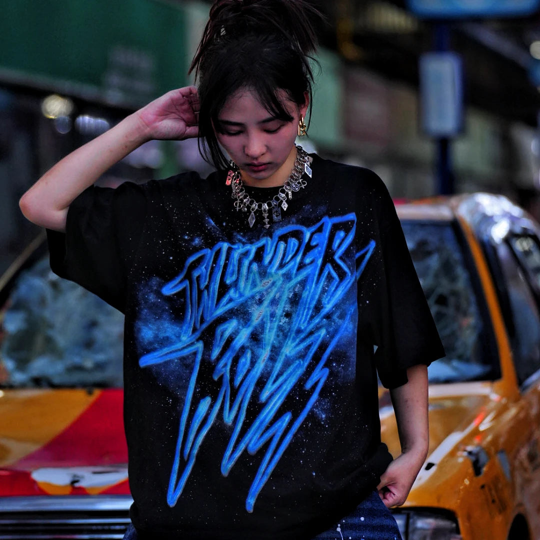 Sanhoostudio short sleeve T-shirt featuring galaxy-inspired graphic artwork, breathable fabric, and a relaxed oversized fit. Perfect for summer streetwear styling with comfort, creativity, and everyday wearability.