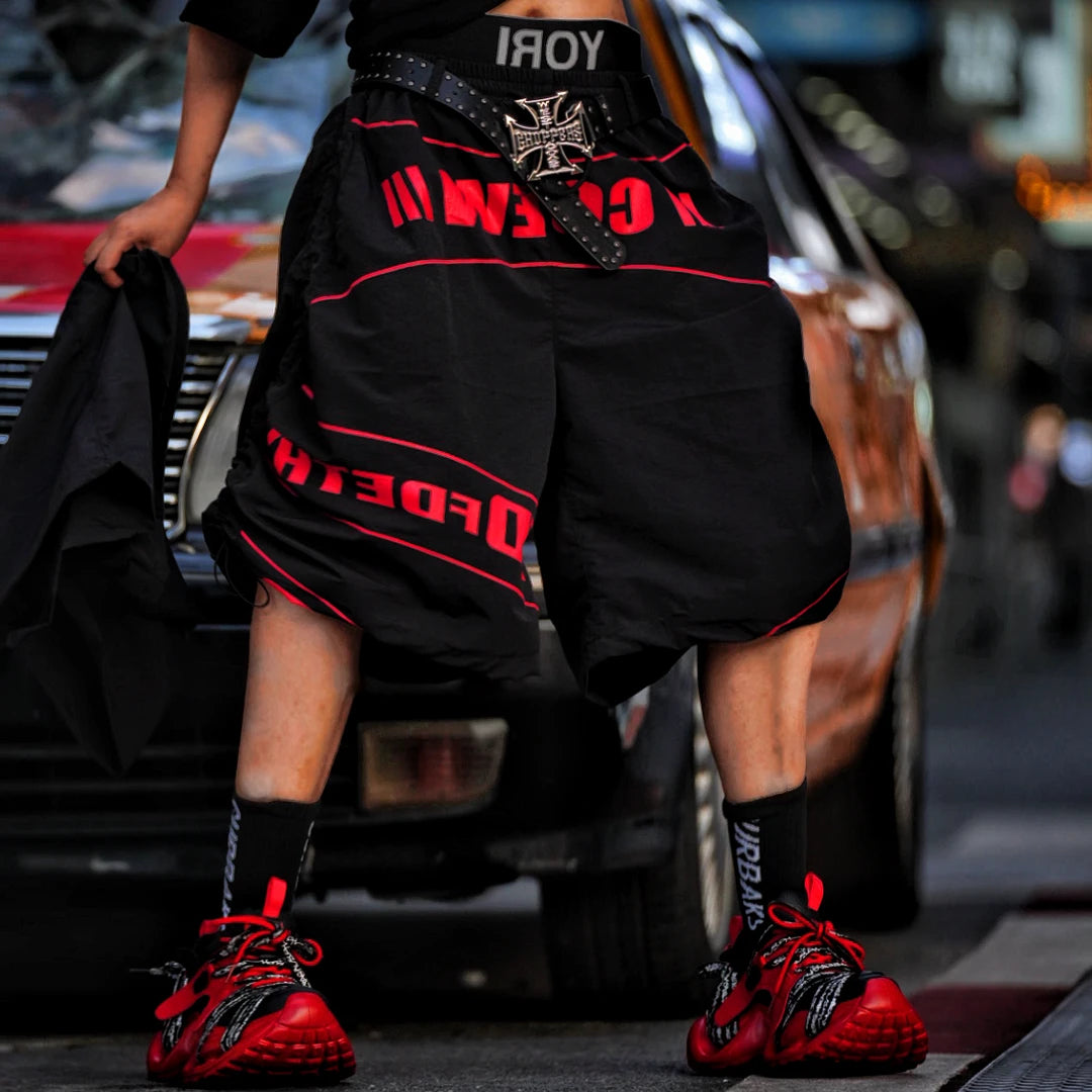 Sanhoostudio track pants featuring detachable design details, racing-inspired panel construction, and lightweight quick-dry fabric. Built for active streetwear styling with comfort, flexibility, and everyday versatility.