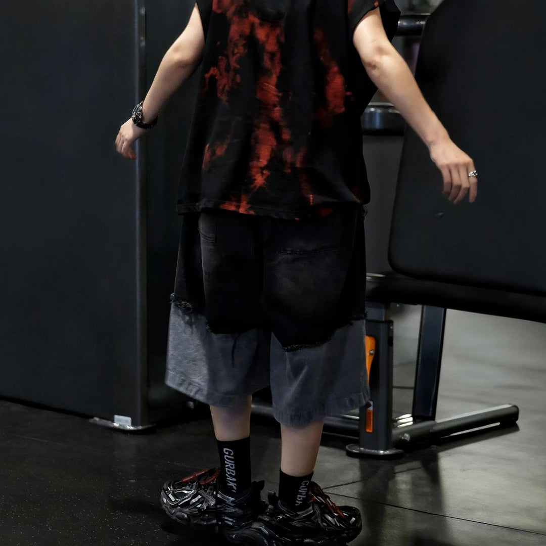Sanhoostudio sleeveless T-shirt featuring distressed detailing, red spray-print artwork, and a relaxed oversized fit. Designed for summer streetwear styling with breathable comfort and a bold urban aesthetic.