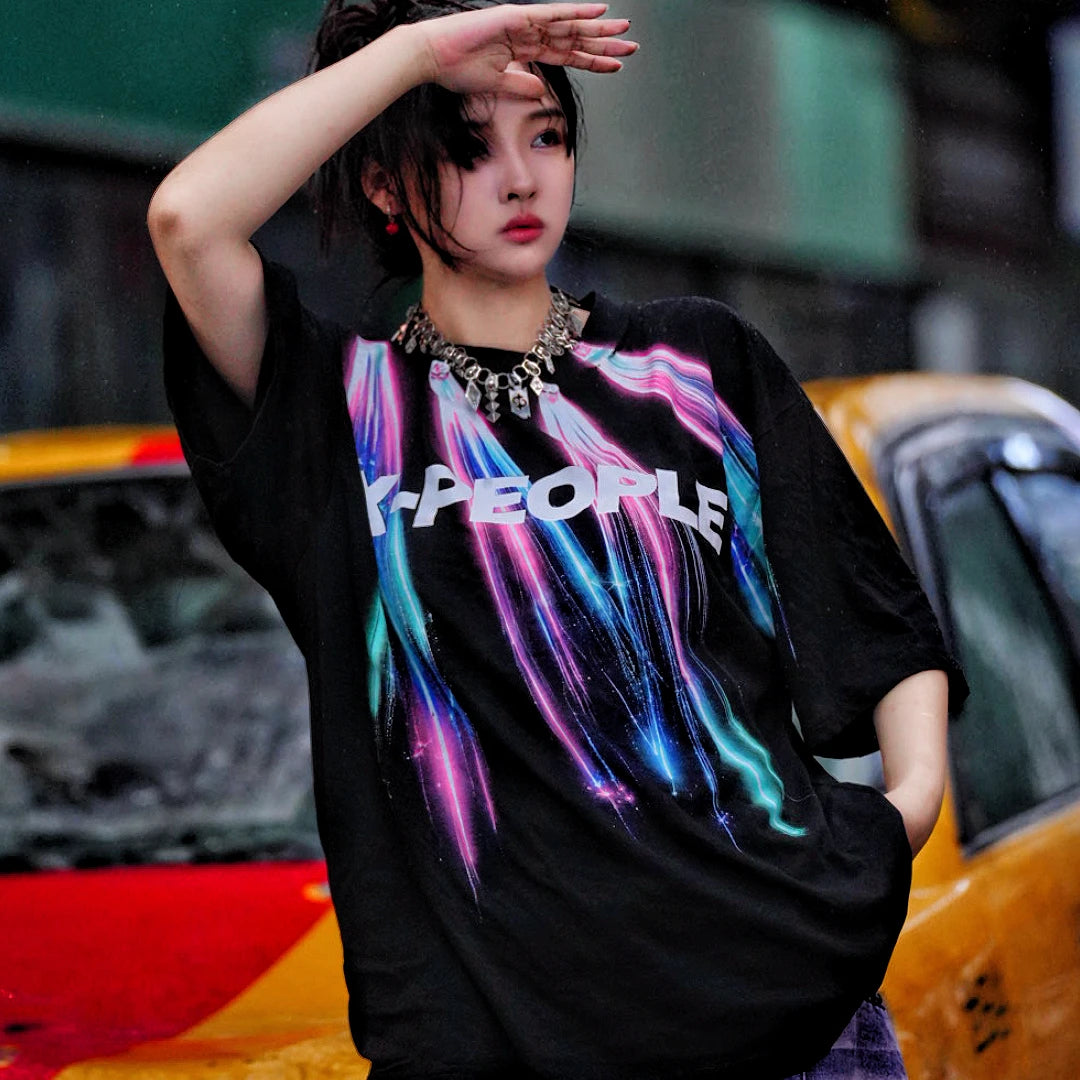 Sanhoostudio short sleeve T-shirt featuring colorful spray-print artwork, breathable fabric construction, and an oversized silhouette. Designed for summer streetwear styling with lightweight comfort and bold graphic appeal.